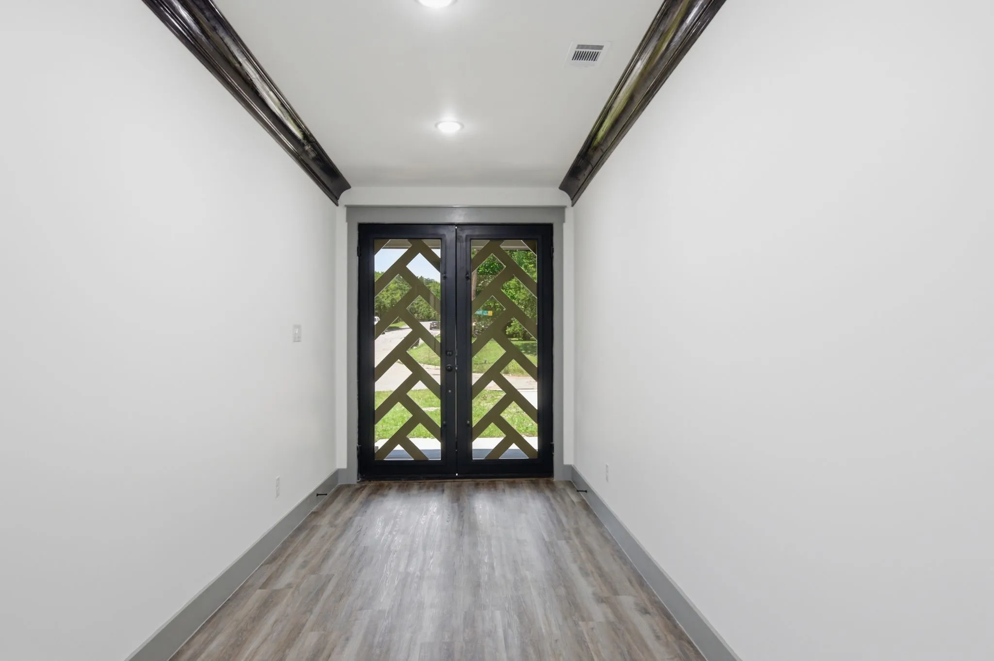 Recessed lighting illuminates the wood-finish flooring