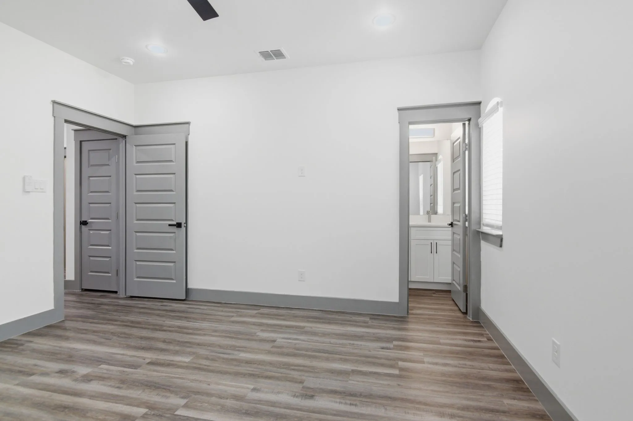 Wood-finish flooring, recessed lighting, and a ceiling fan