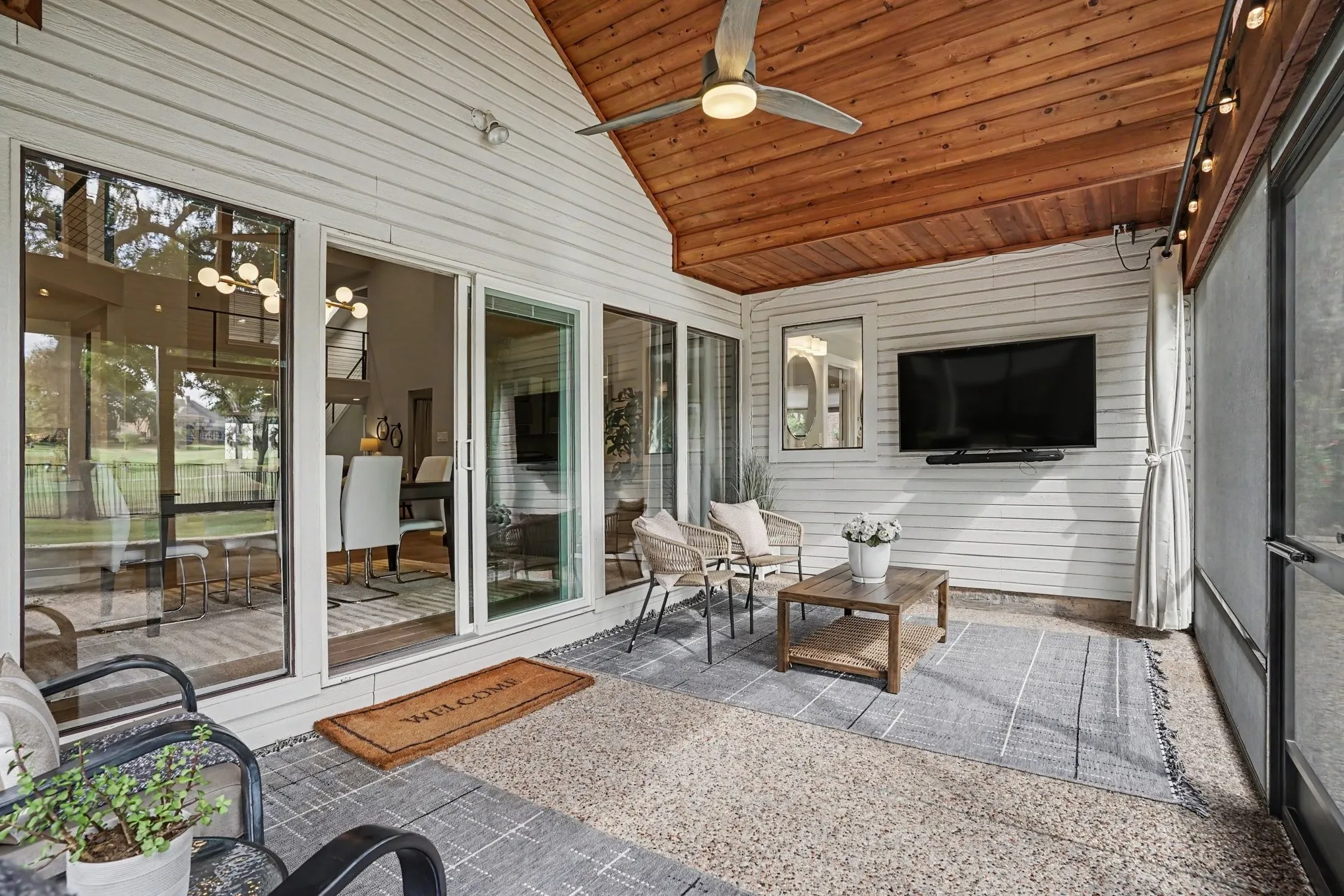 Screened in patio with ceiling fan and large sliding door
