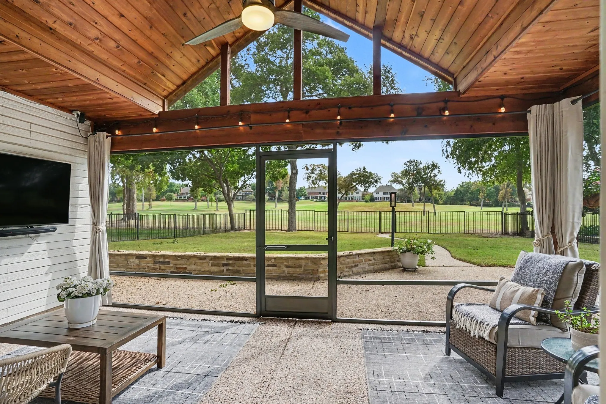Screened in patio with gorgeous vaulted wood ceilng