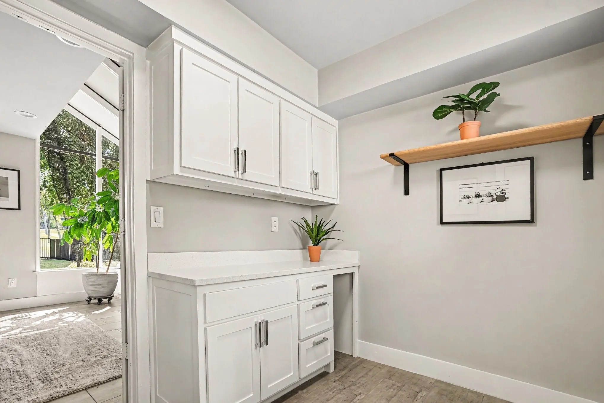Separate laundry room with cabinets and door to driveway
