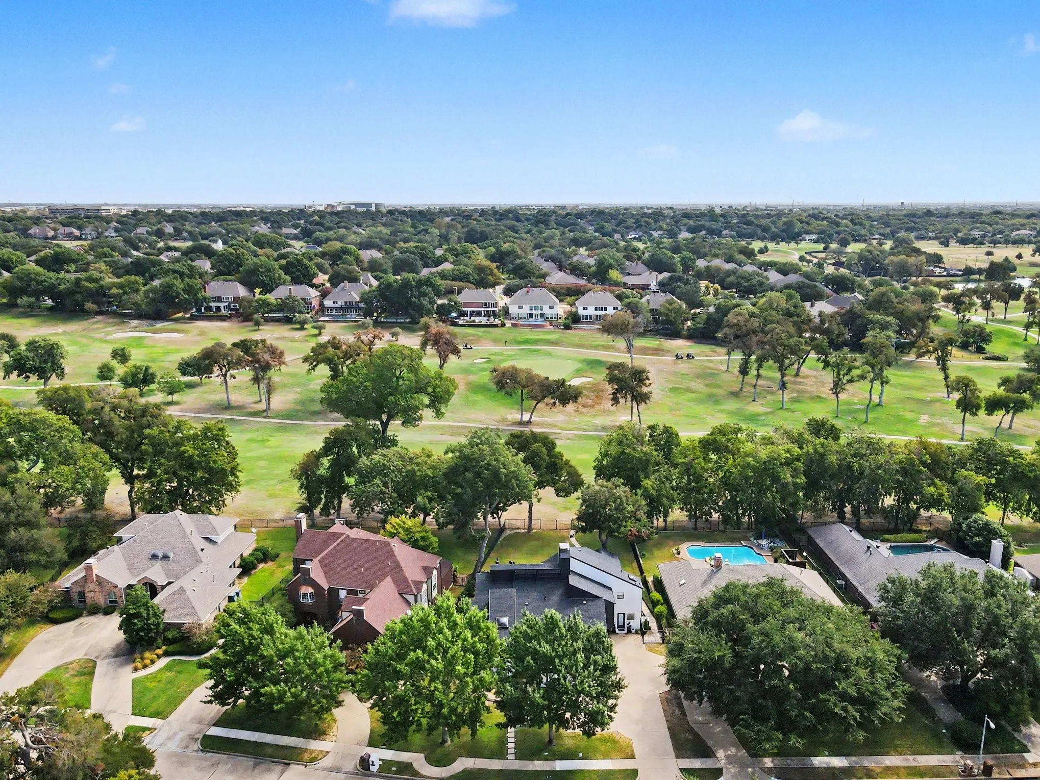 Home sits on golf course with lots of large trees