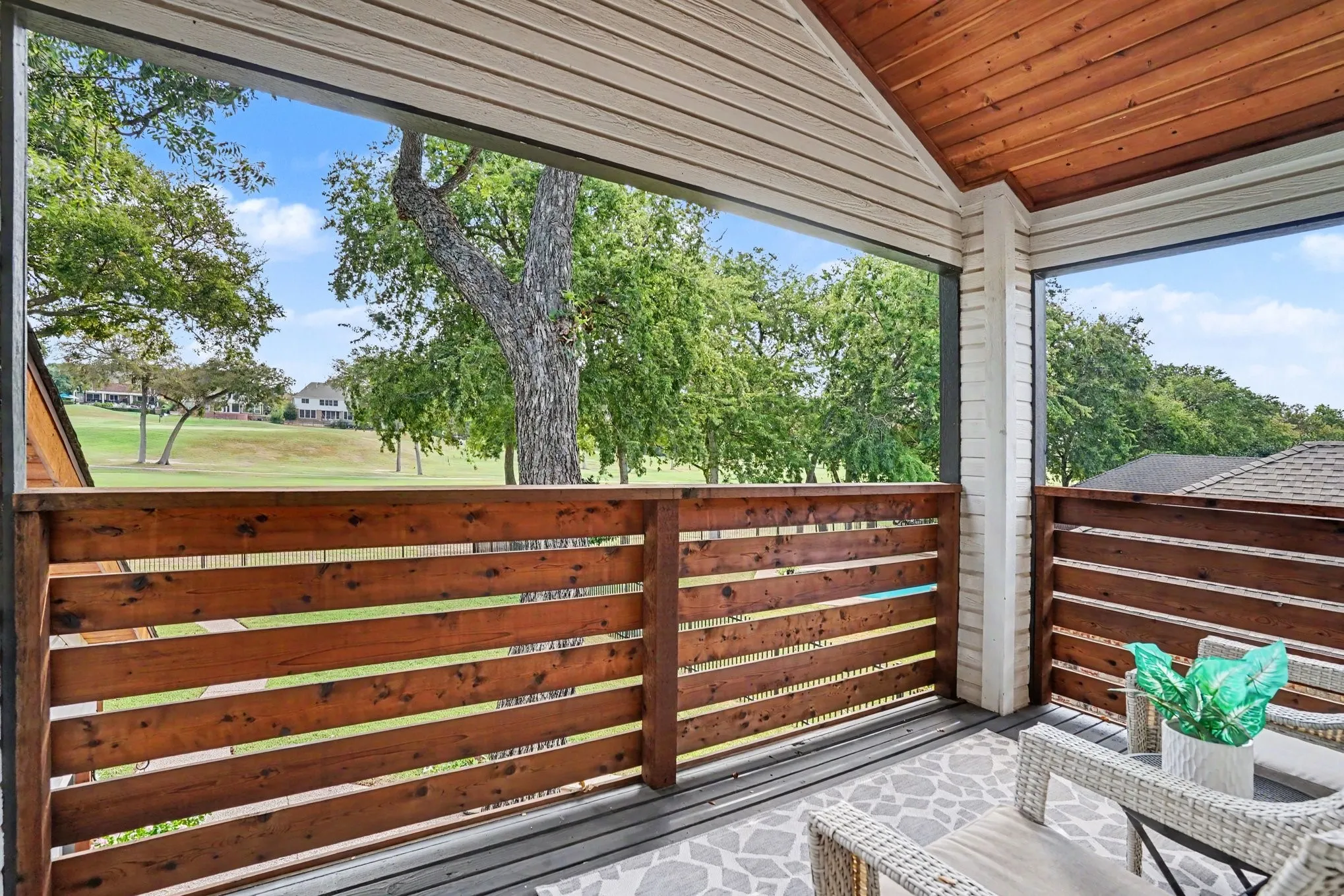 Balcony off guest room at back of house overlooking golf course