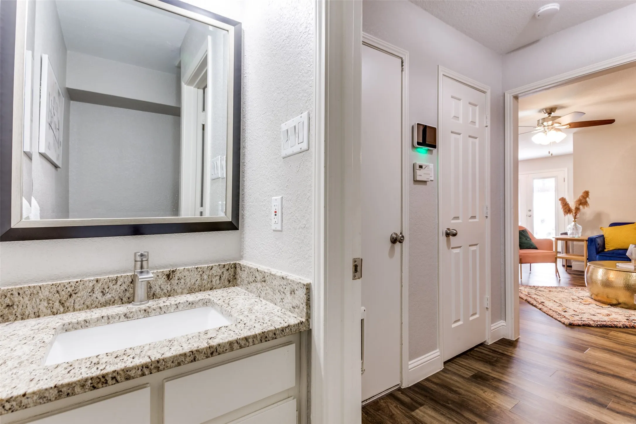 Vanity with stone-finish countertop, integrated sink, and chrome faucet