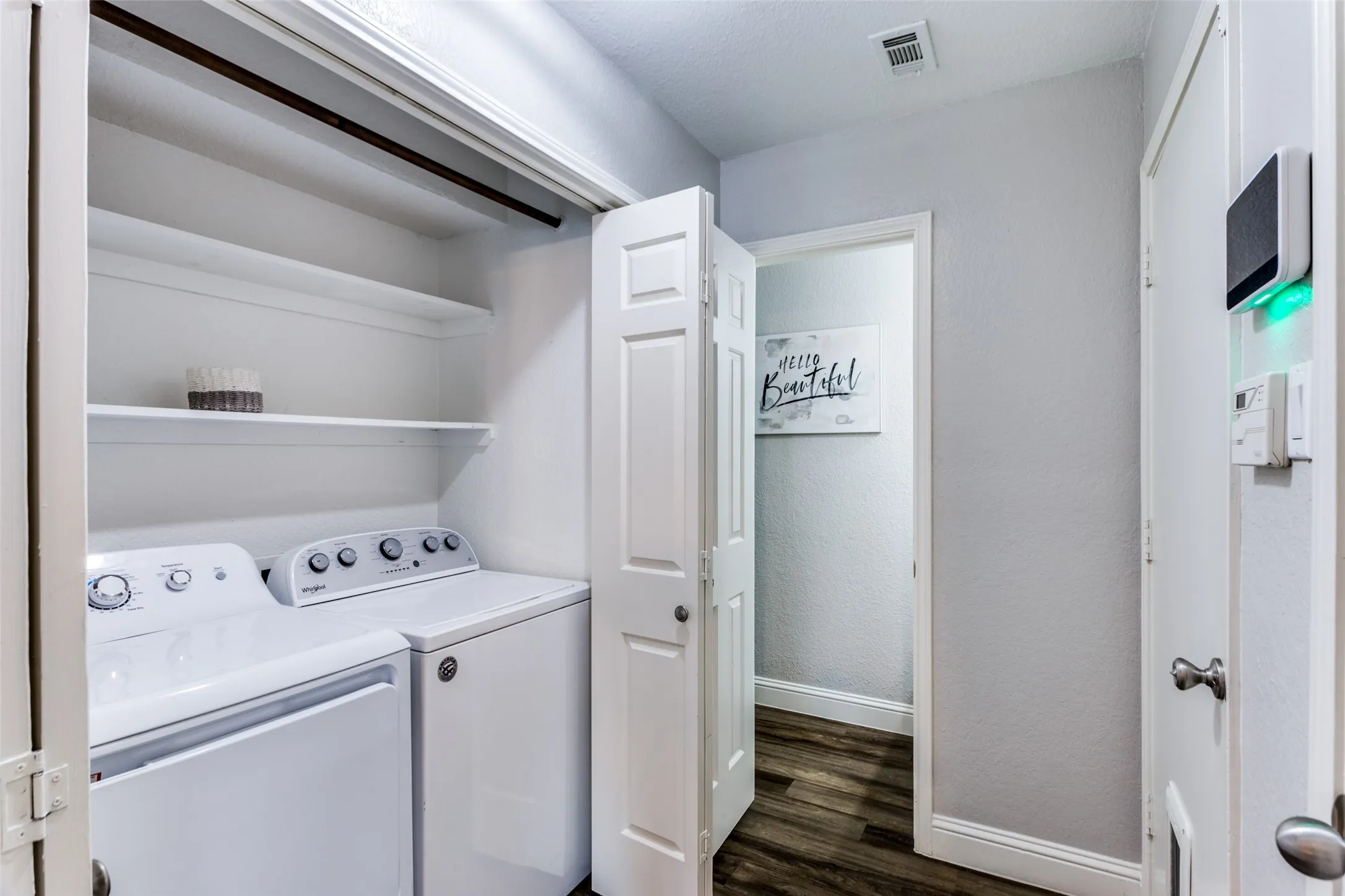 Built-in shelving, wood-finish flooring, white paneled doors, and white trim