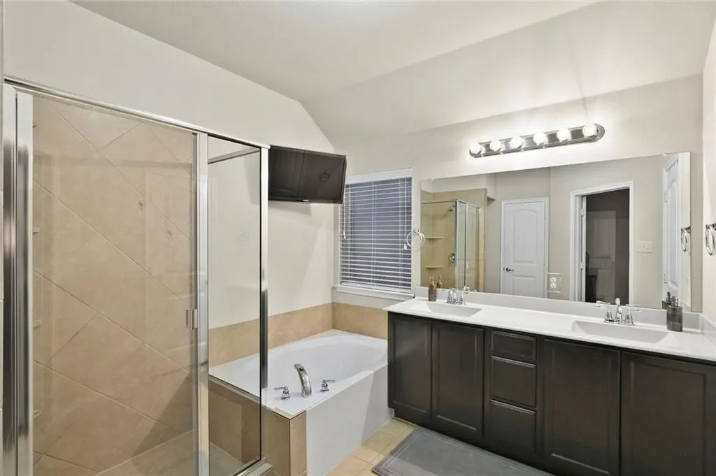 Dual vanity with undermount sinks, integrated countertop, and dark wood-finish cabinetry