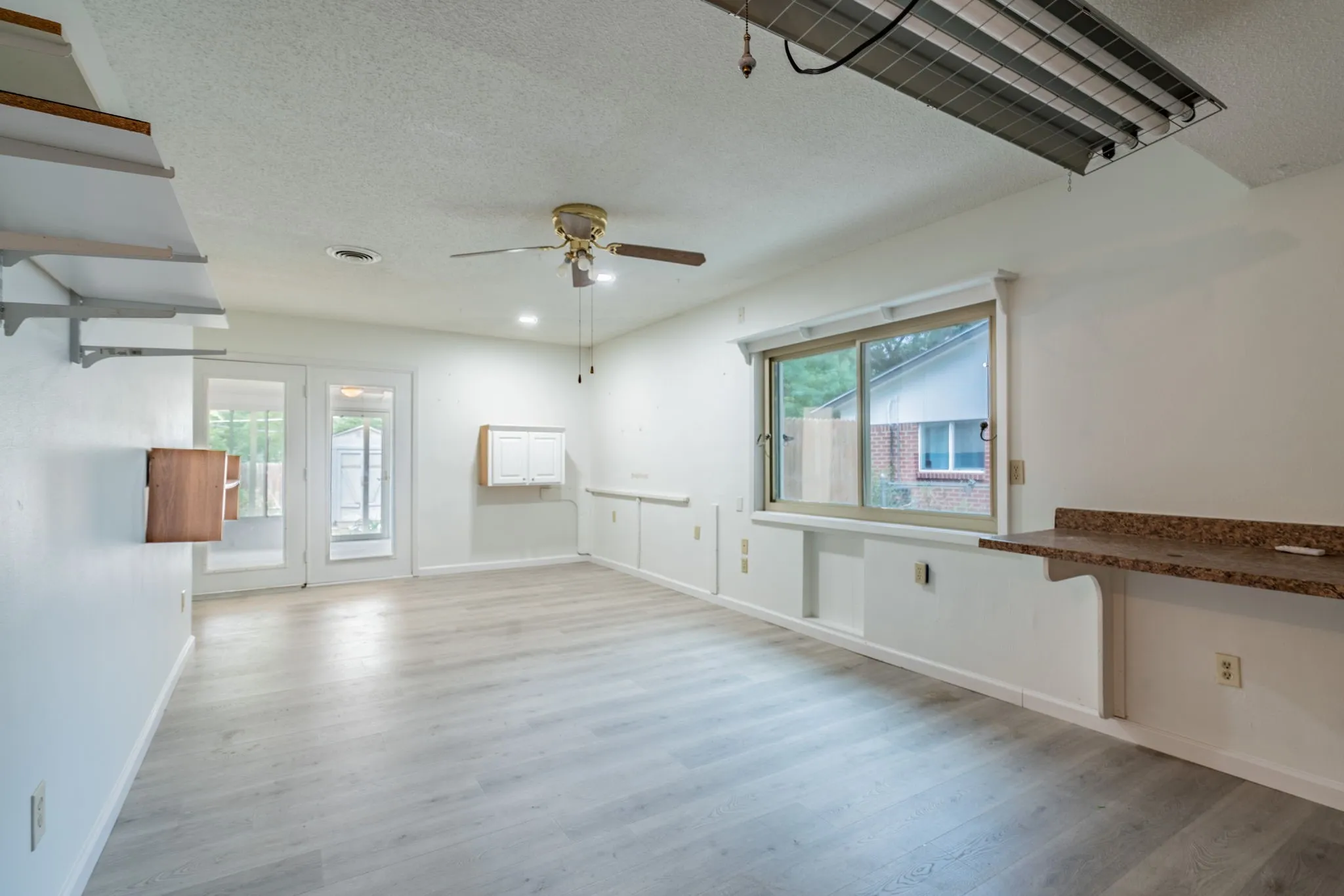 Light wood-finish flooring with white walls
