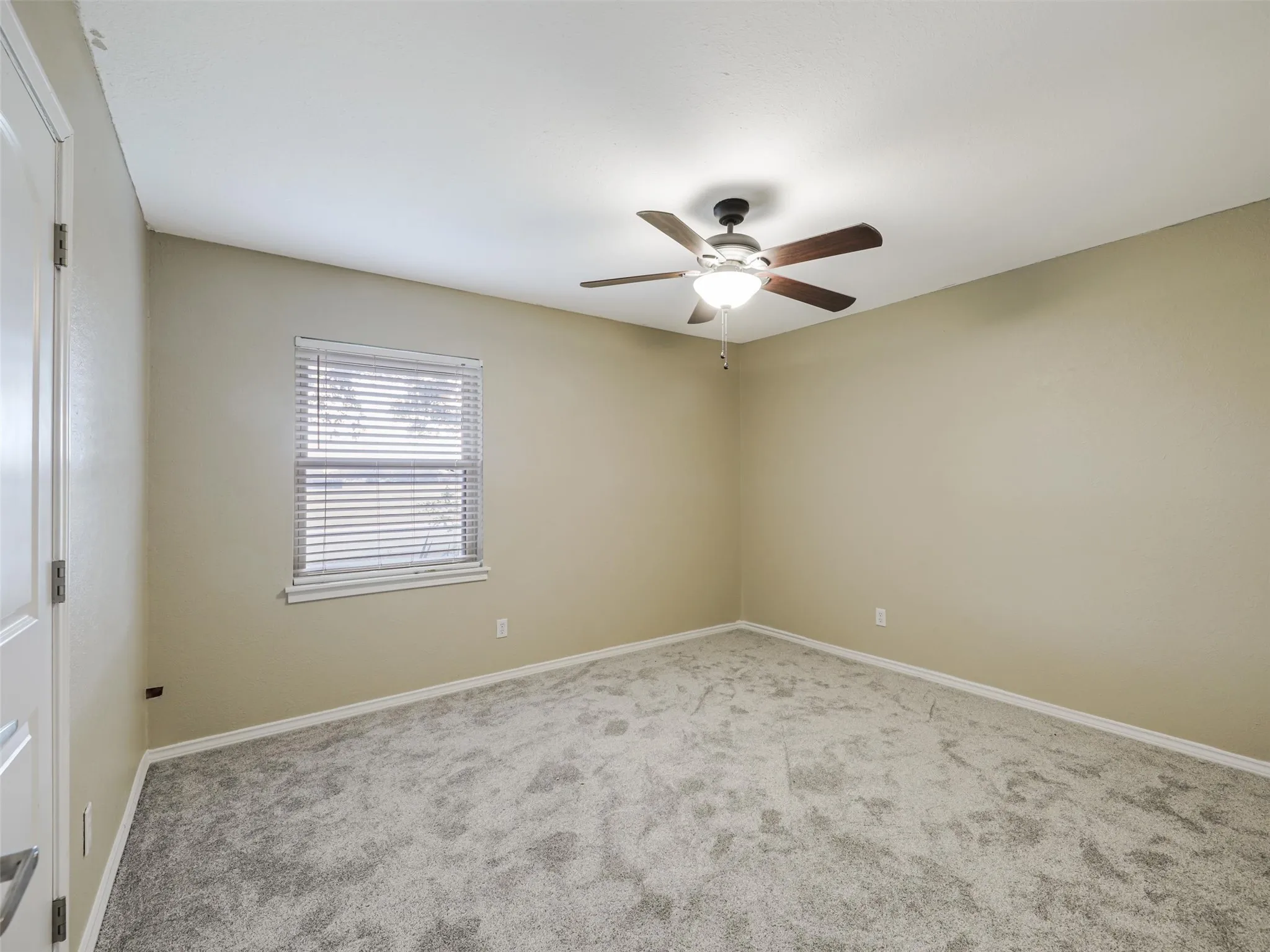 Neutral-toned walls complement the gray carpeting