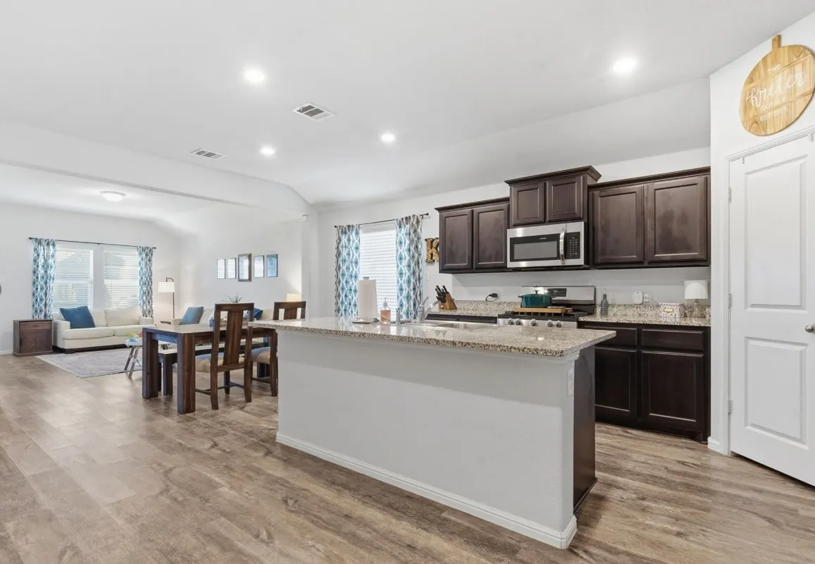 Open concept living area with wood-finish flooring