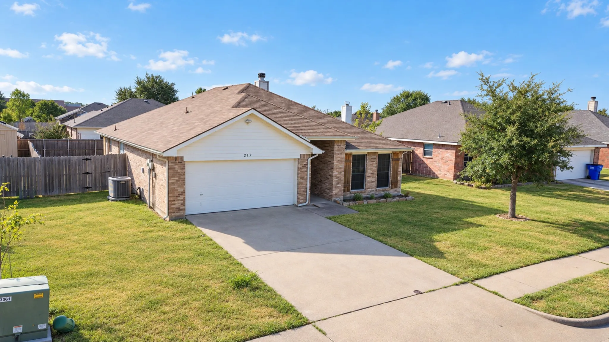 Brick exterior with a gabled roof and attached garage