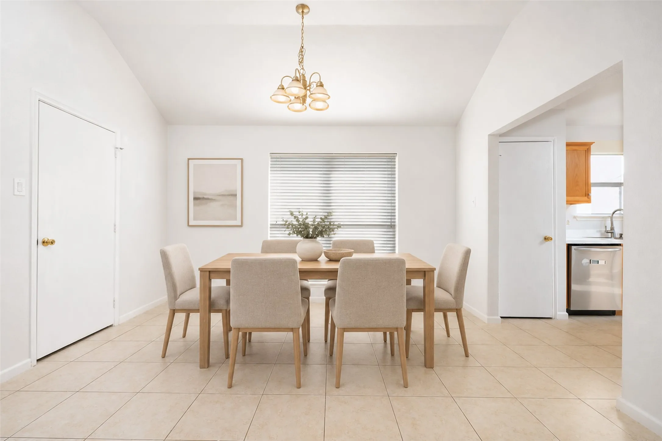 Vaulted ceilings, tile flooring, window with blinds, and an arched entryway