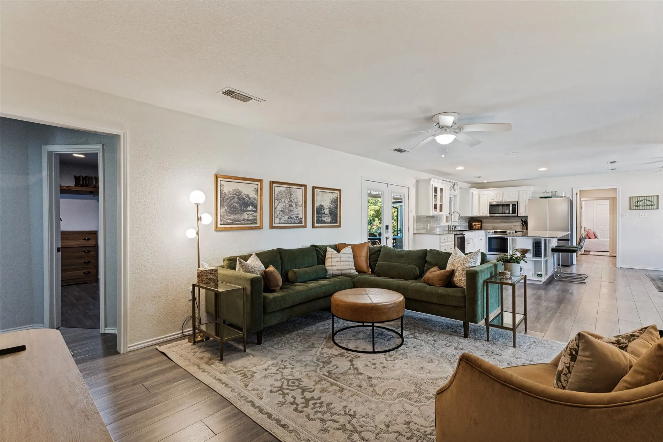 Open-concept living space featuring wood-finish flooring and a ceiling fan