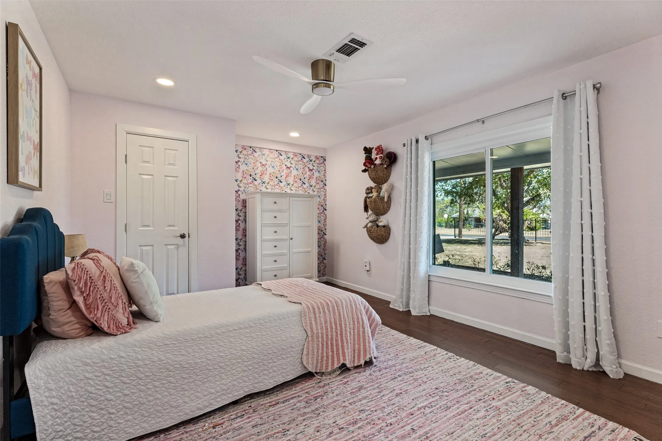 Recessed lighting, ceiling fan, wood-finish flooring, white trim, and a large window