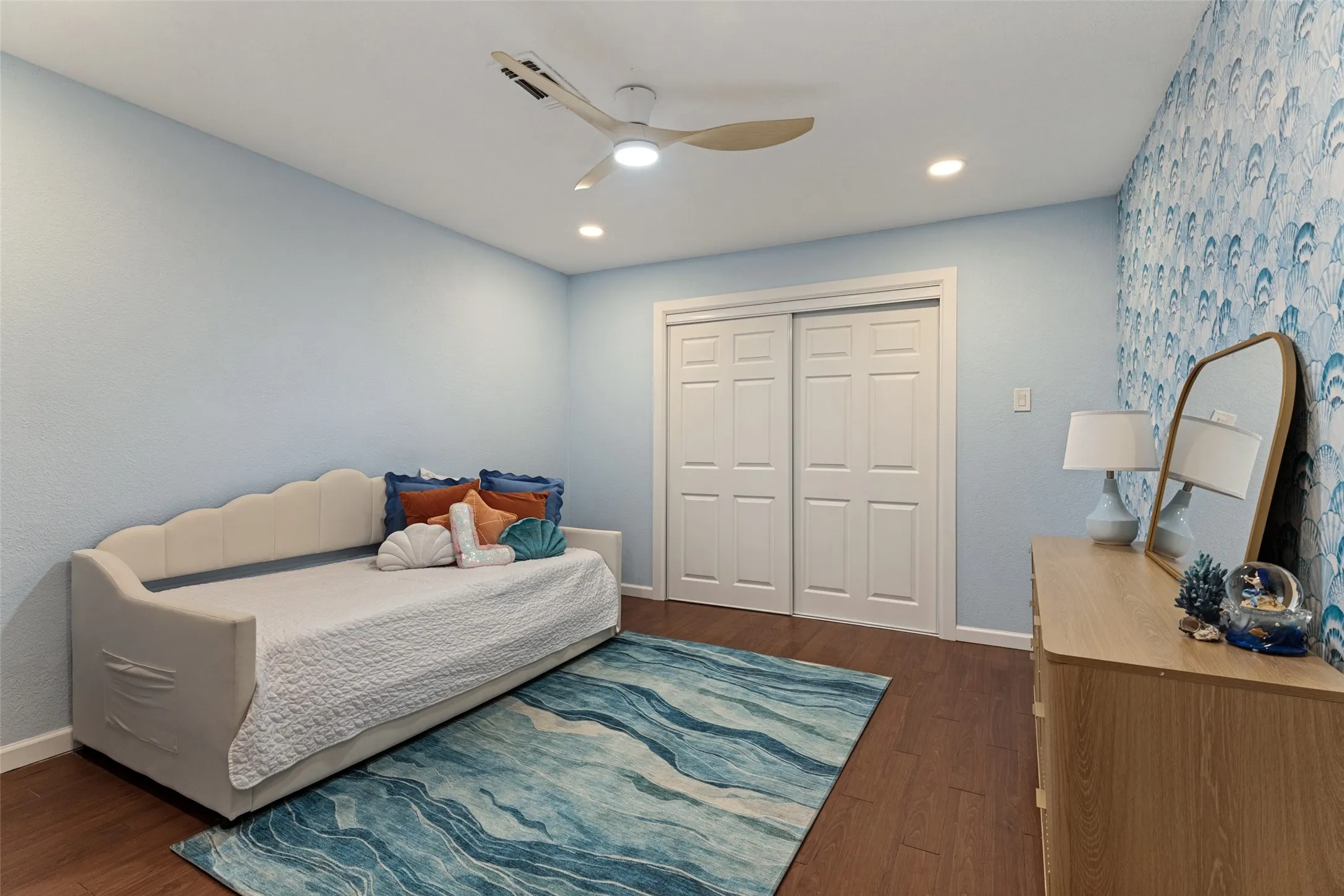 Wood-finish flooring, recessed lighting, and a ceiling fan with integrated lighting