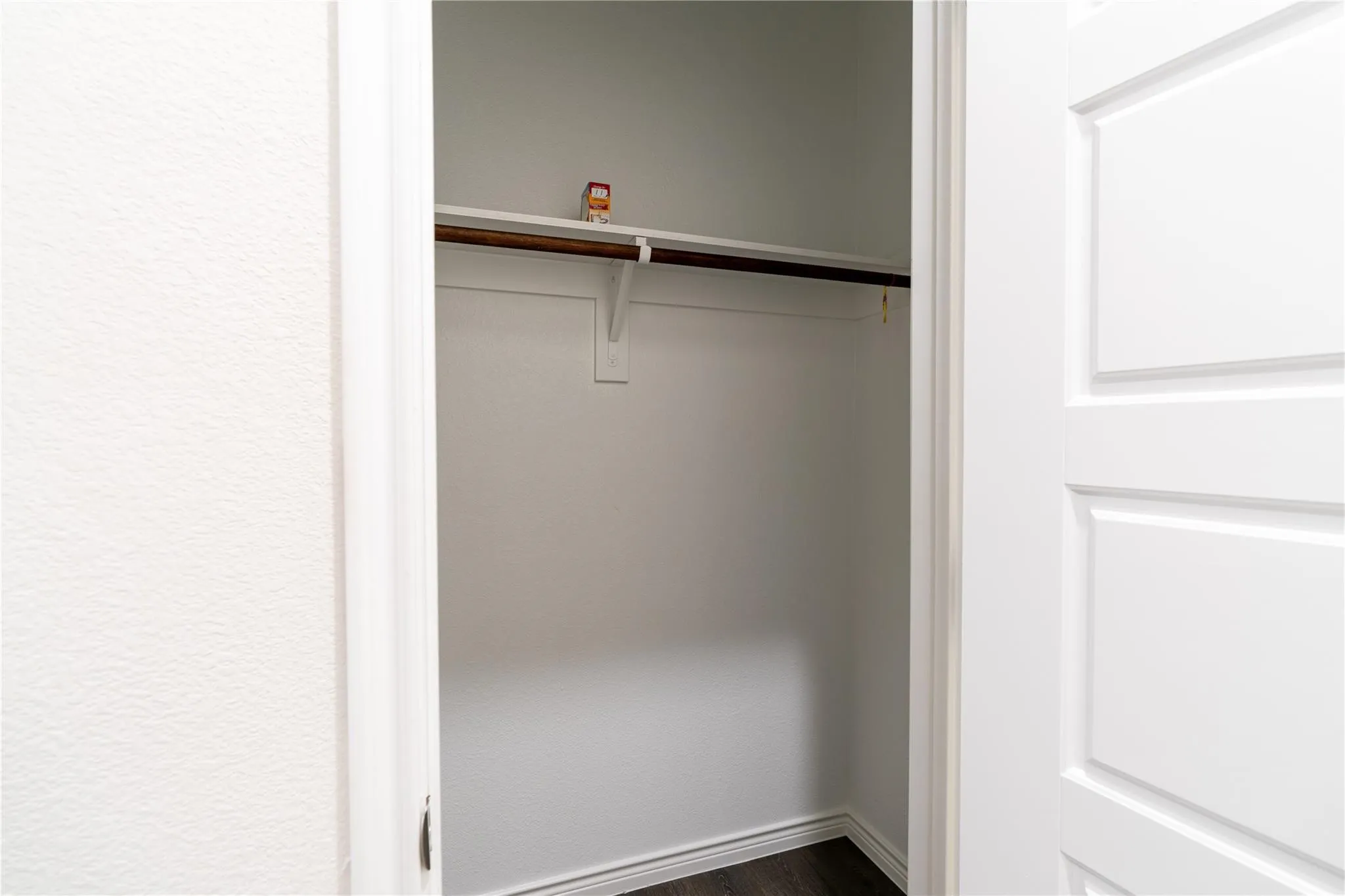 Built-in closet with a hanging rod and integrated shelving