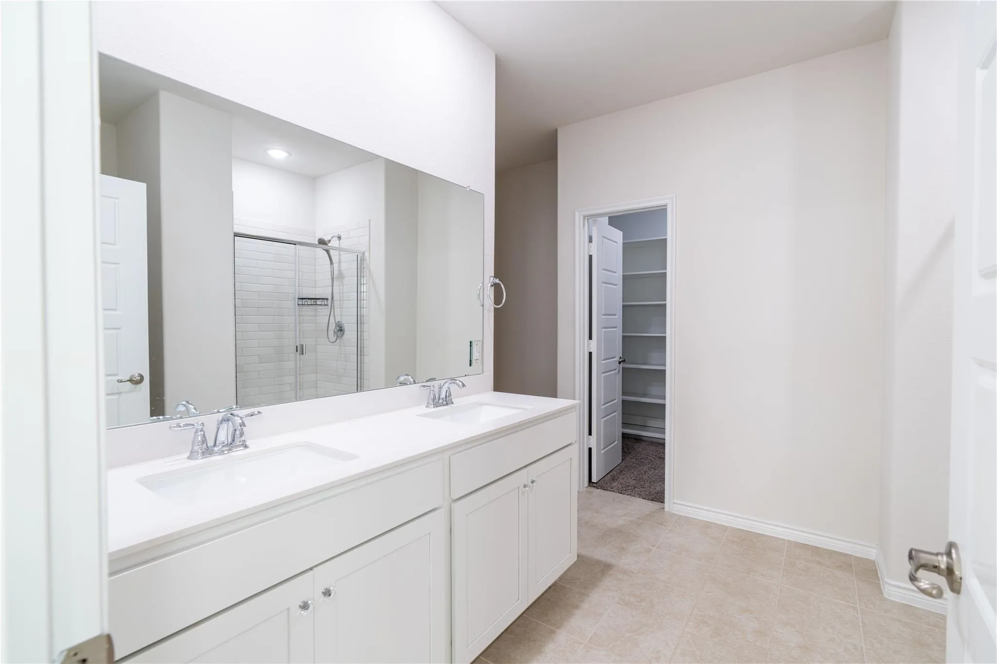 Dual vanity with white cabinetry and integrated sinks