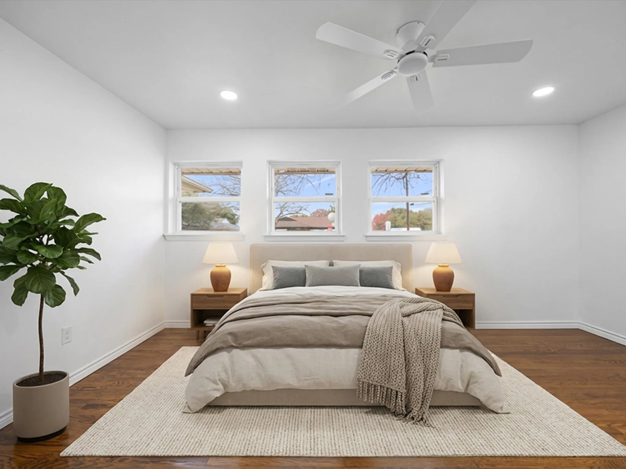 Rich wood-finish flooring, recessed lighting, and a ceiling fan with light fixture