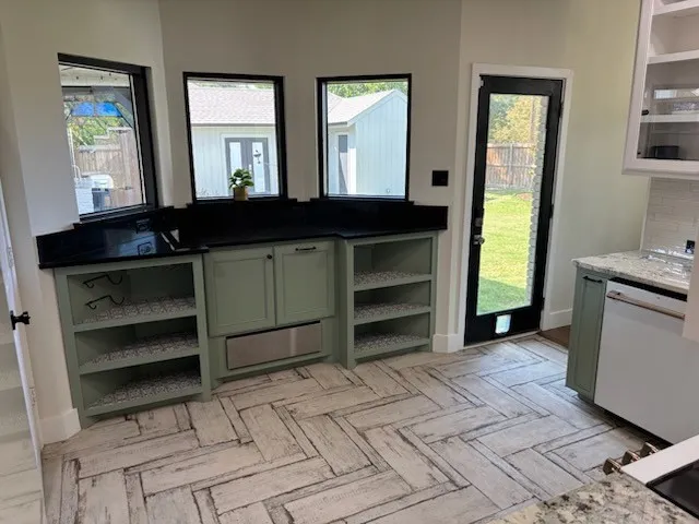Built-in cabinetry with a black granite countertop with lots of storage