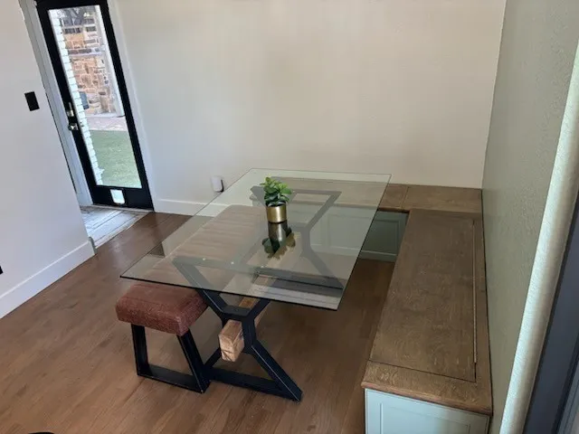 Built-in banquette seating with a wood-finish top and cabinet storage
