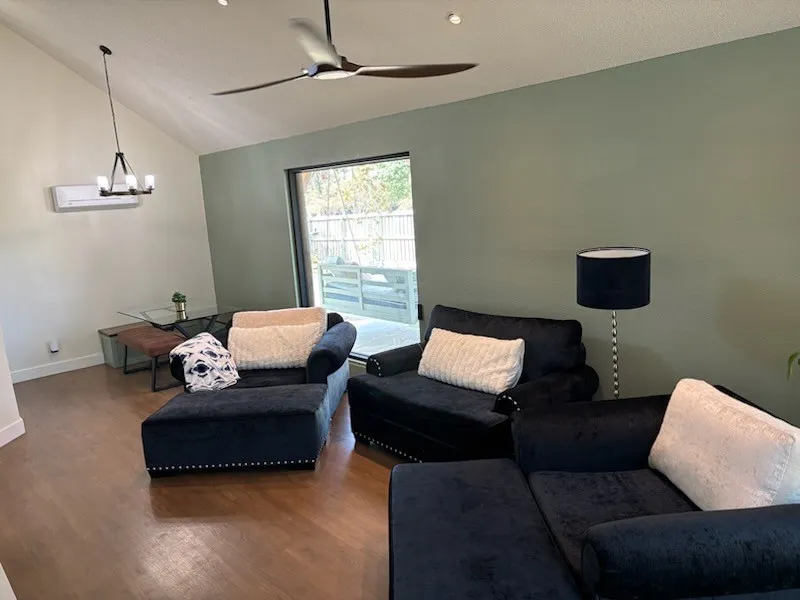 Cozy living room overlooks the kitchen and dining areas