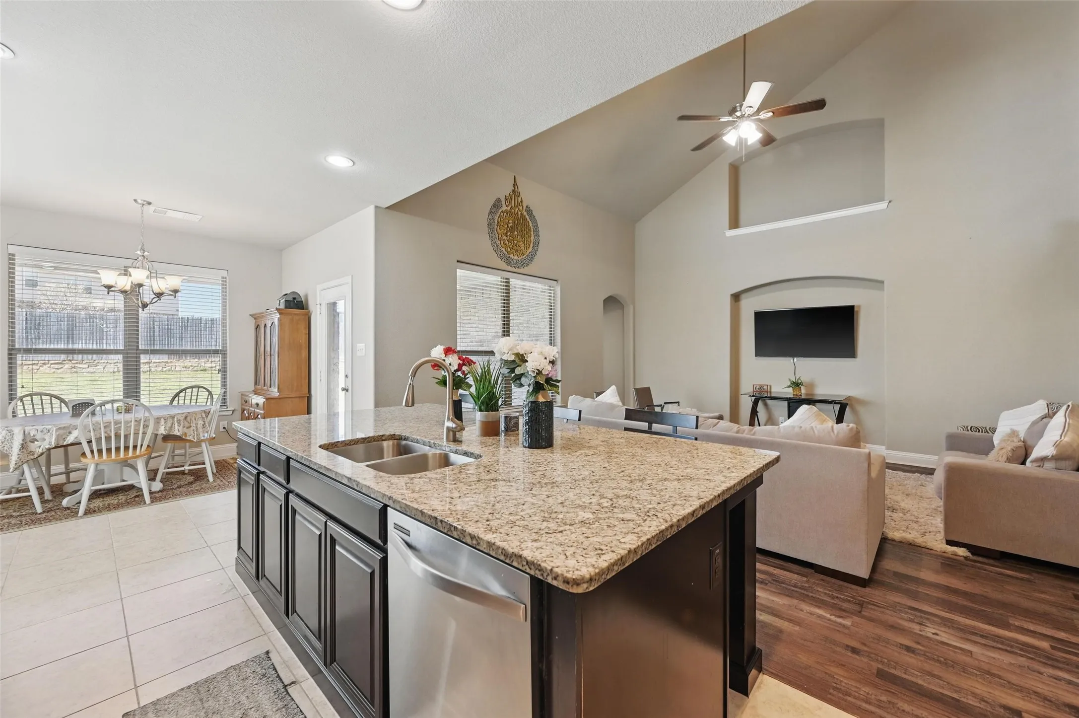 Kitchen island with a granite countertop and dual basin stainless steel sink