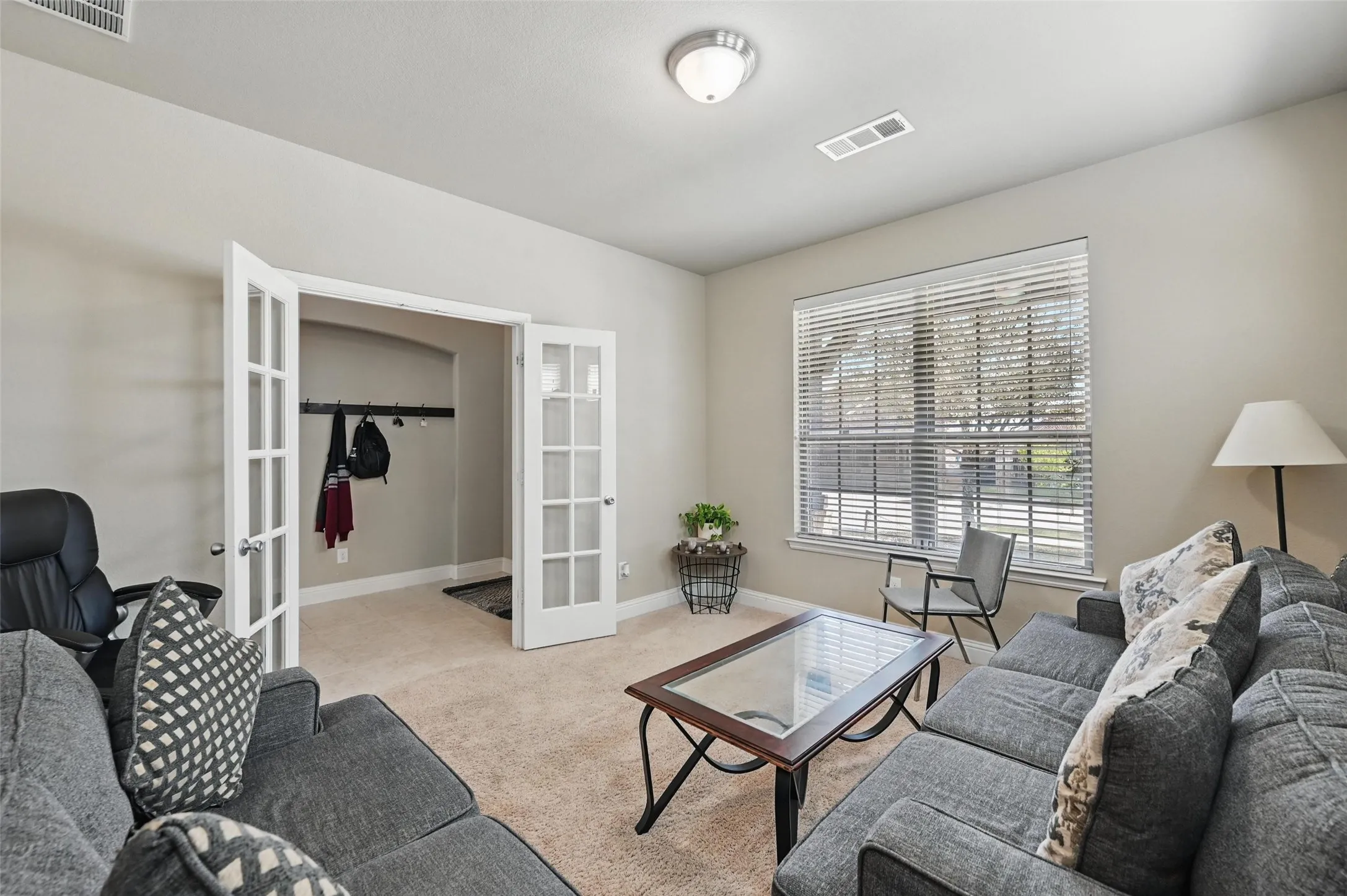 Recessed lighting, neutral wall tones, and carpet flooring