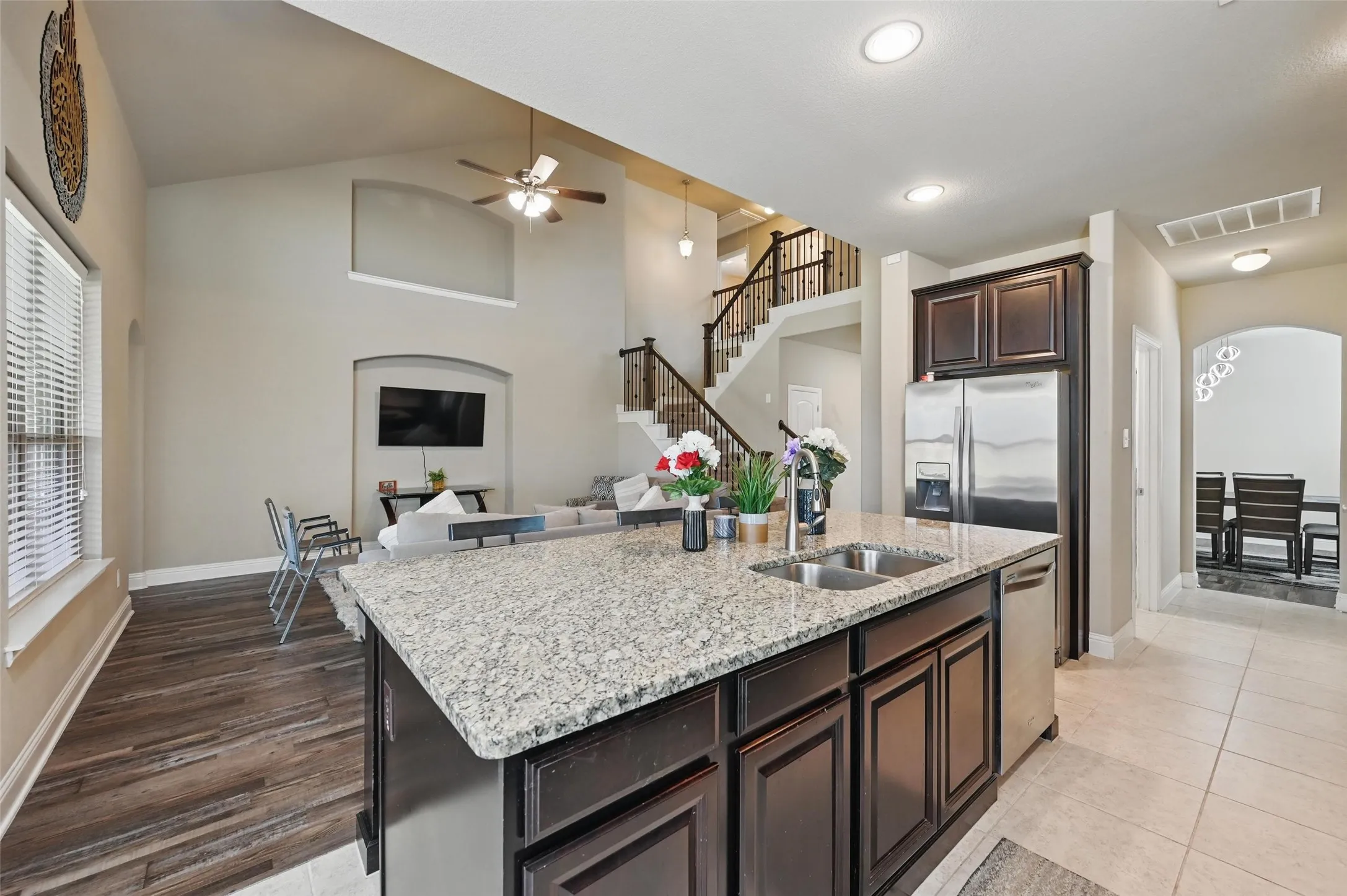 Kitchen island with a dual-basin stainless steel sink and granite-style countertop