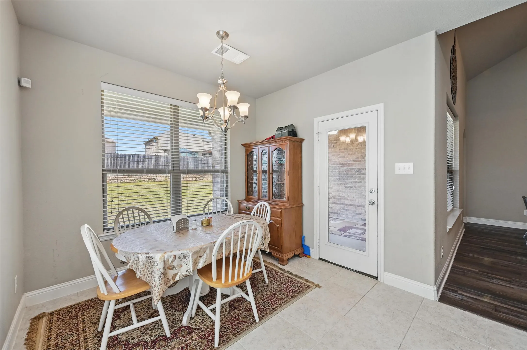 Tile flooring, recessed lighting, and a glass-paneled exterior door