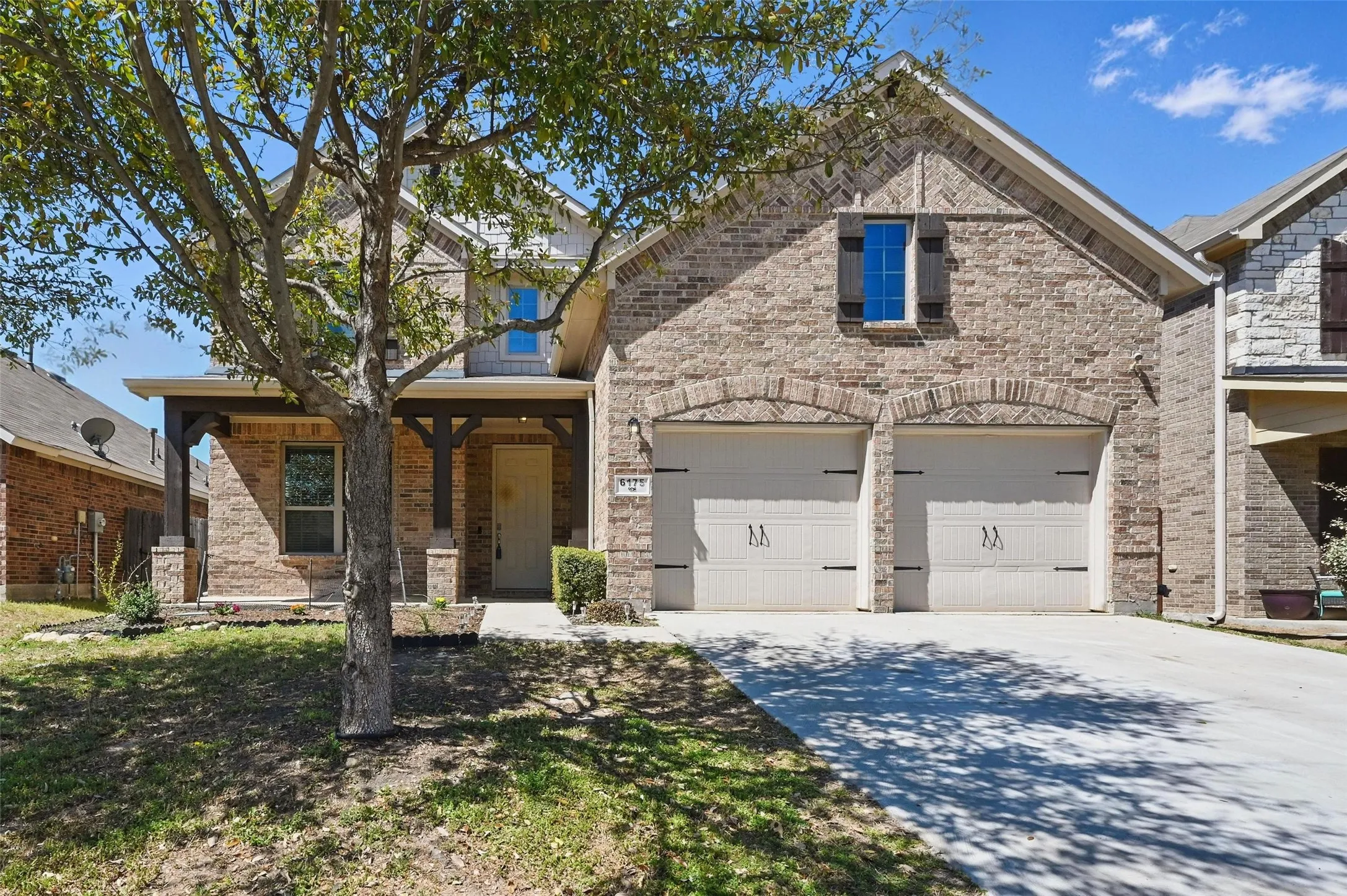 Brick and stone veneer exterior with a covered porch