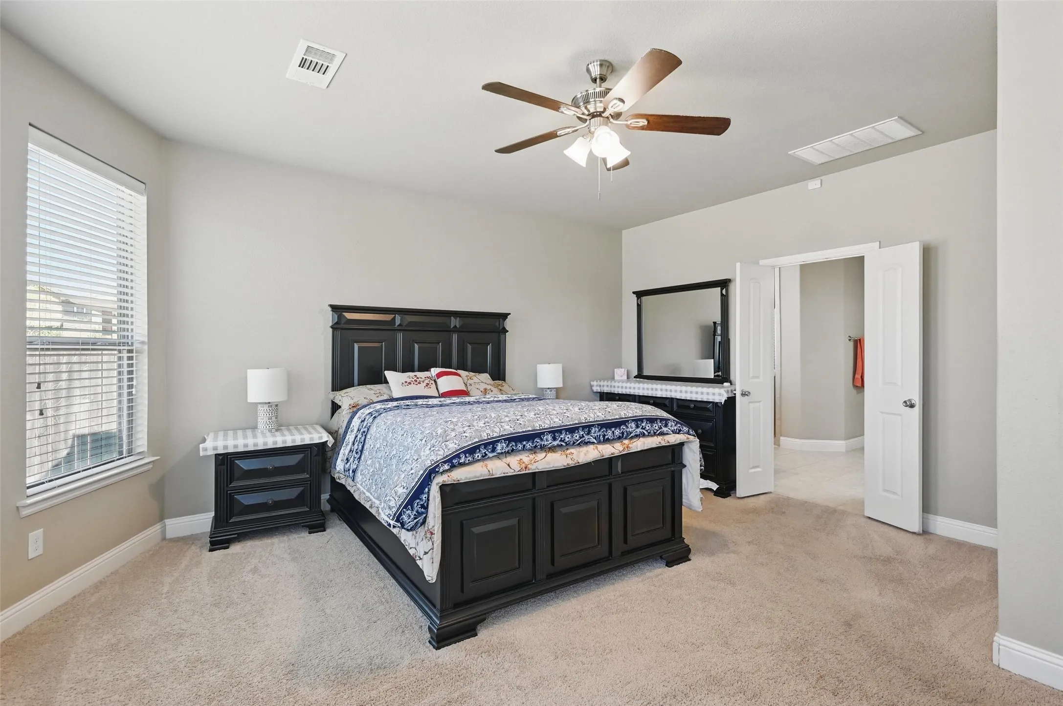 Carpeted flooring throughout, recessed window, and ceiling fan with integrated lighting