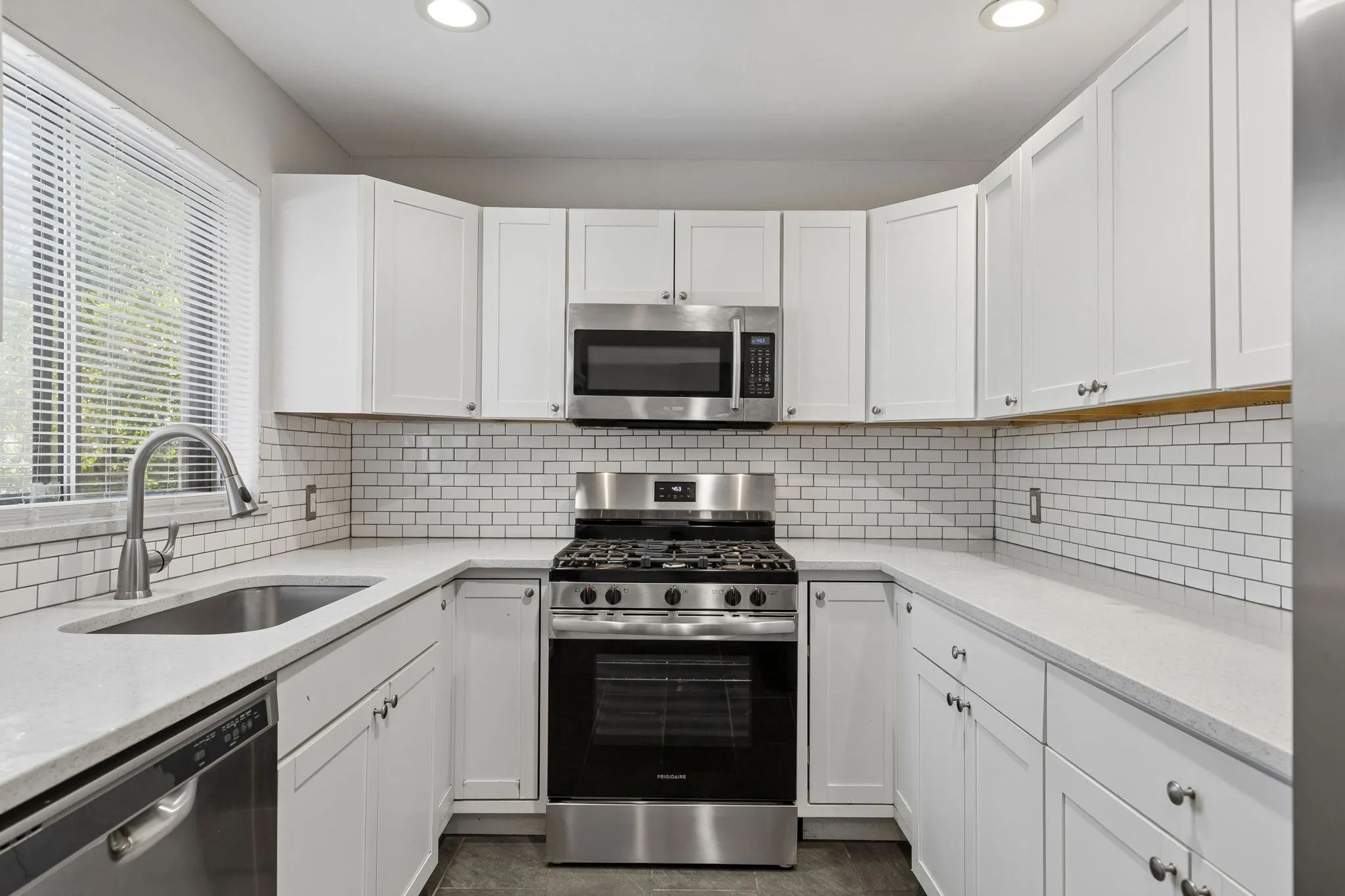 Kitchen with stainless steel appliances and quartz countertops