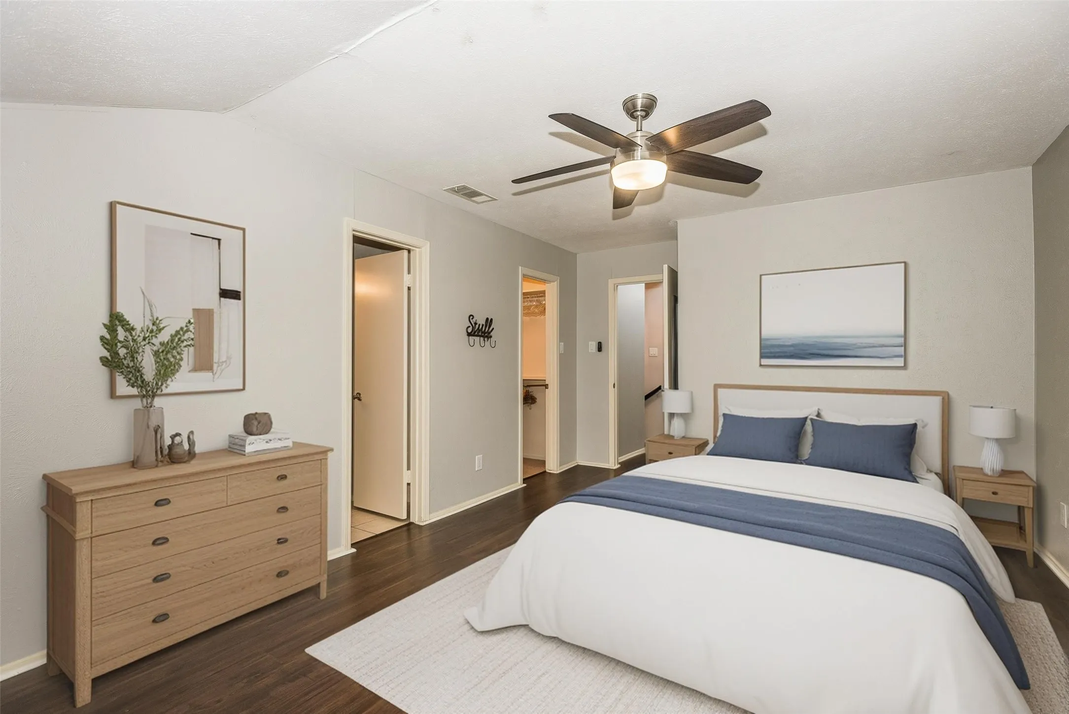 1st Bedroom & ensuite bath-Wood-finish flooring, ceiling fan with integrated lighting, and neutral wall tones