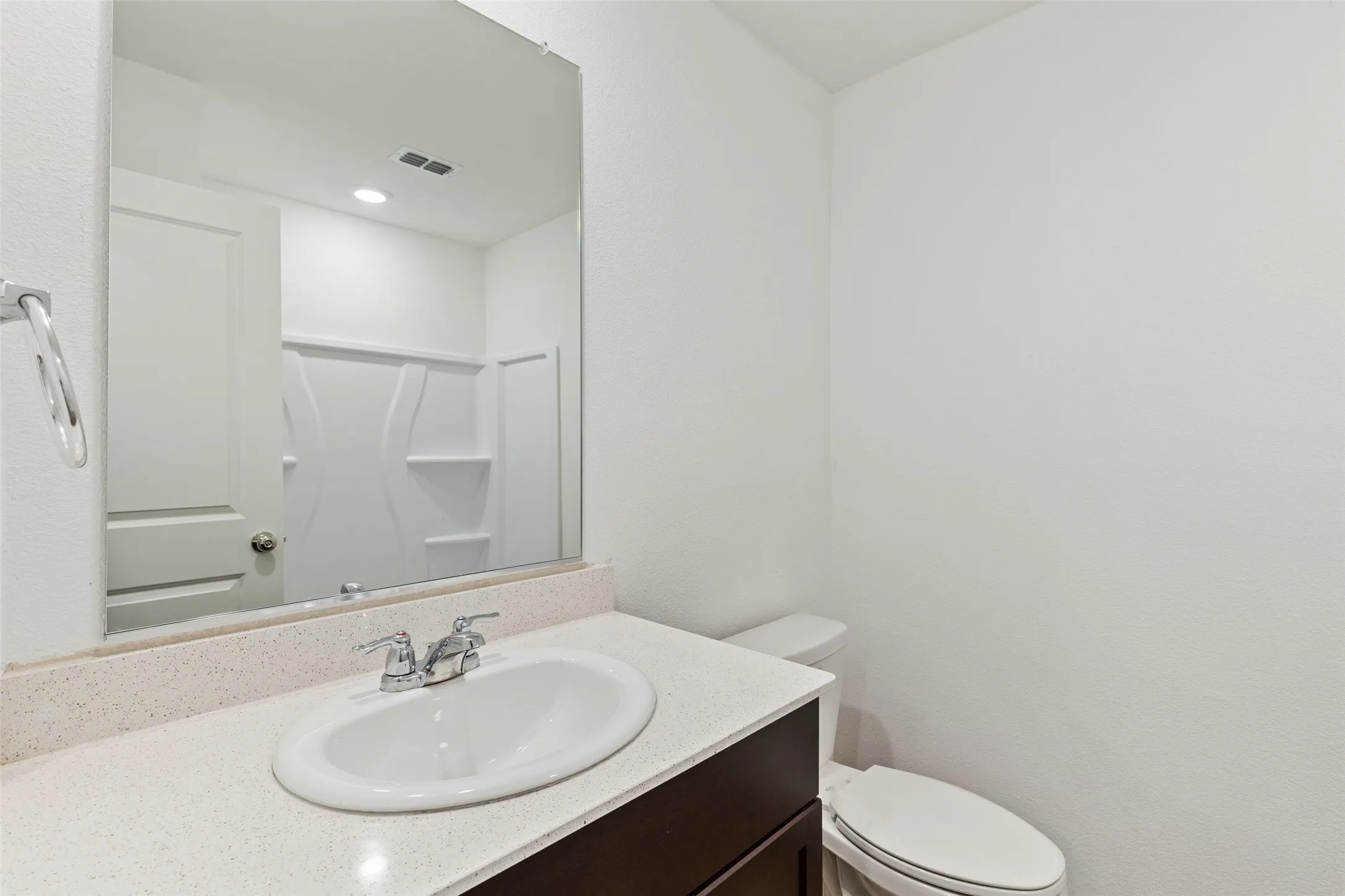 Vanity with a light-toned countertop, undermount sink, and chrome fixtures