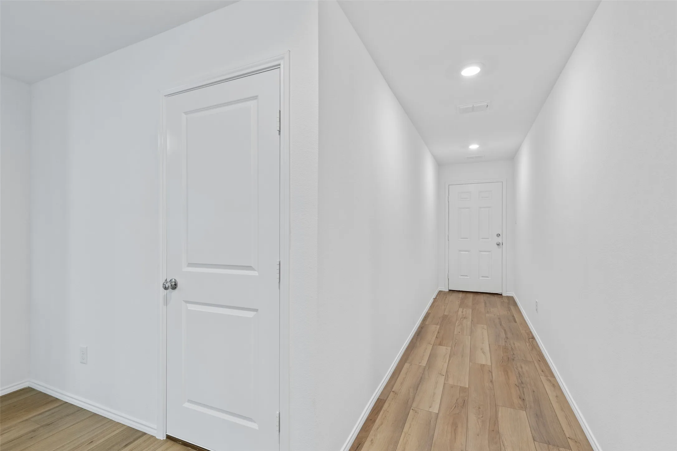 Bright white walls with wood-finish flooring