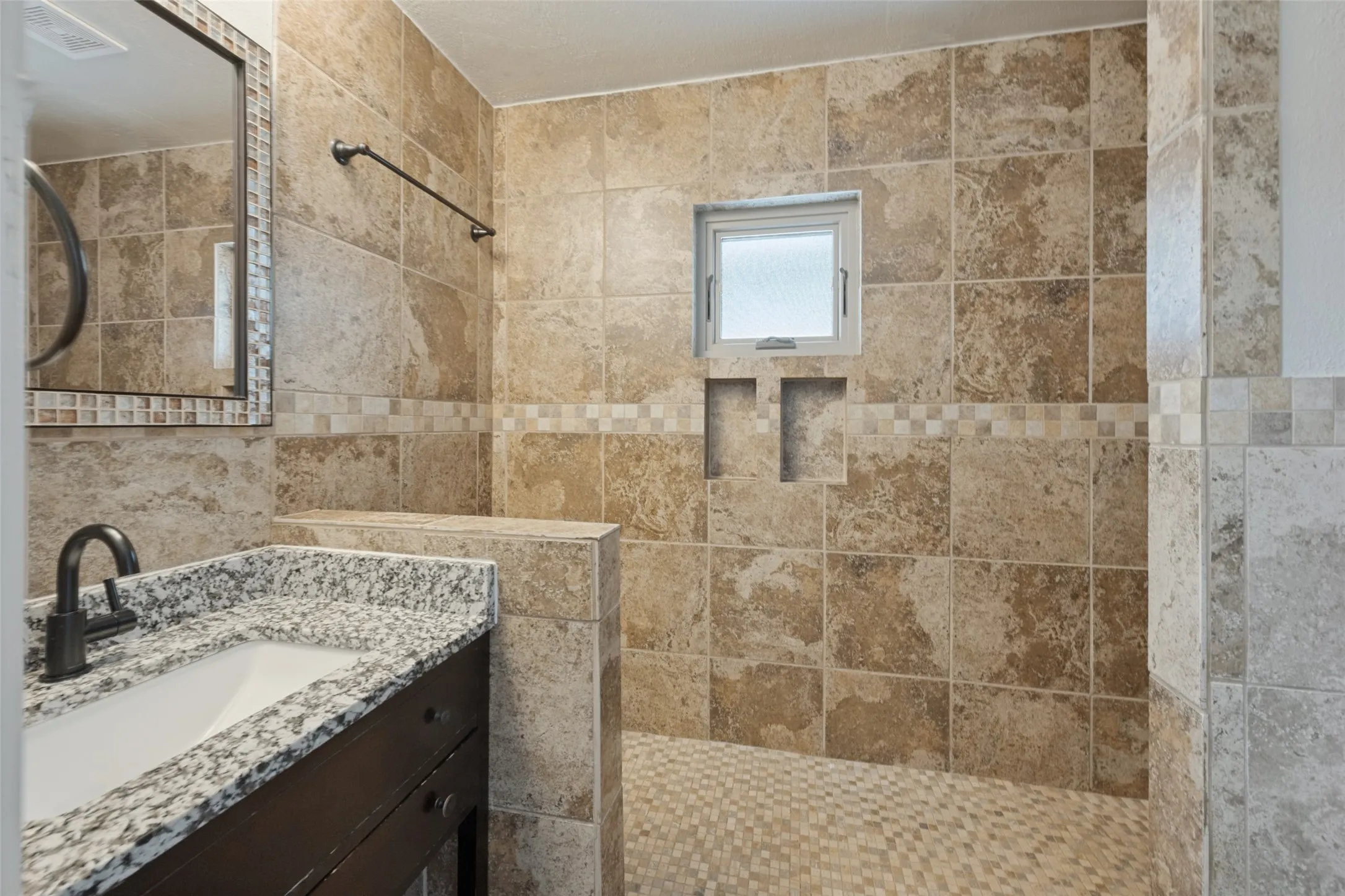 Tiled shower with built-in bench and recessed shelving