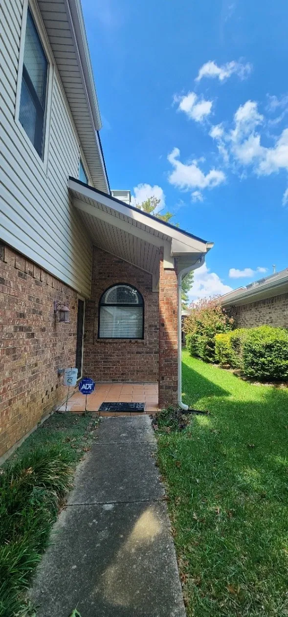 Brick and siding exterior with a covered entry
