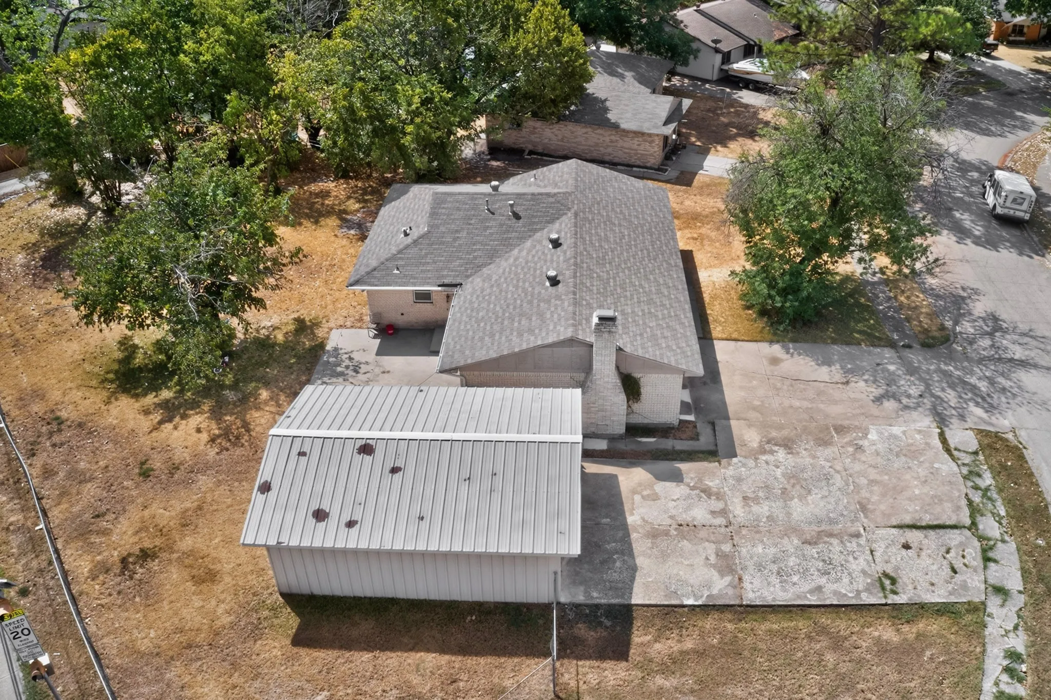 Asphalt shingle roofing with a stone-clad chimney