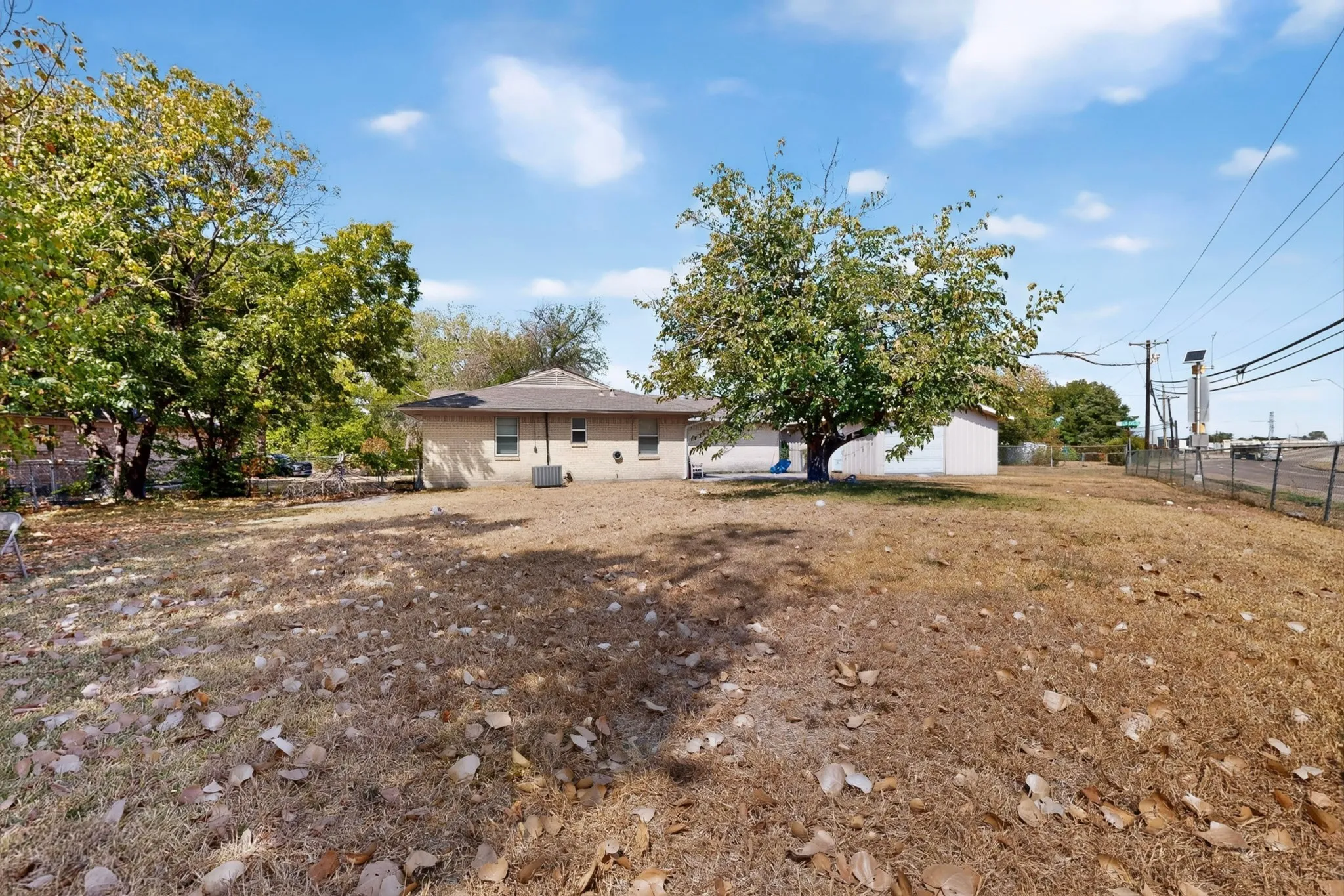 Expansive lot with mature trees and a fenced perimeter