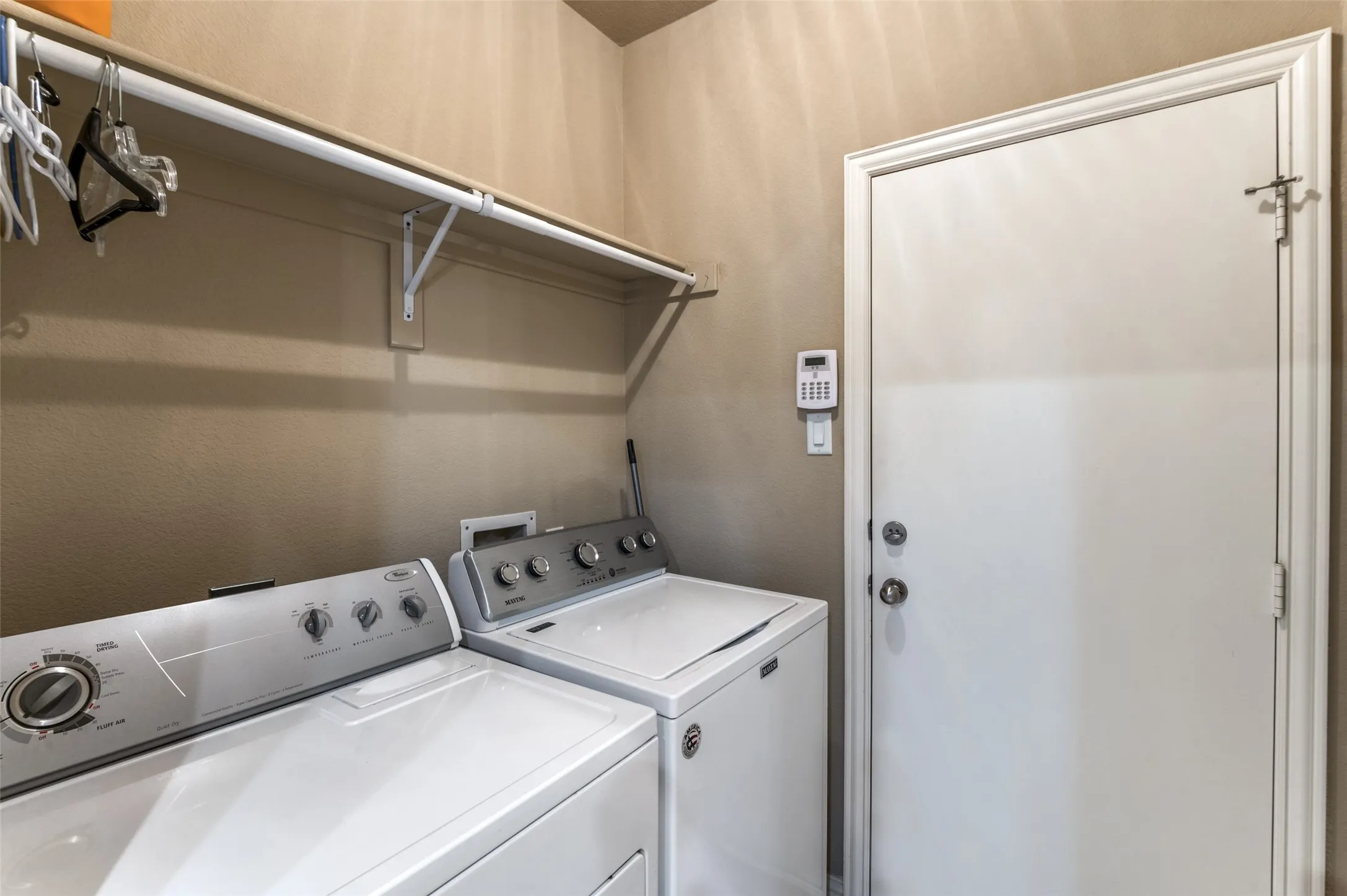 Laundry area with upper shelving