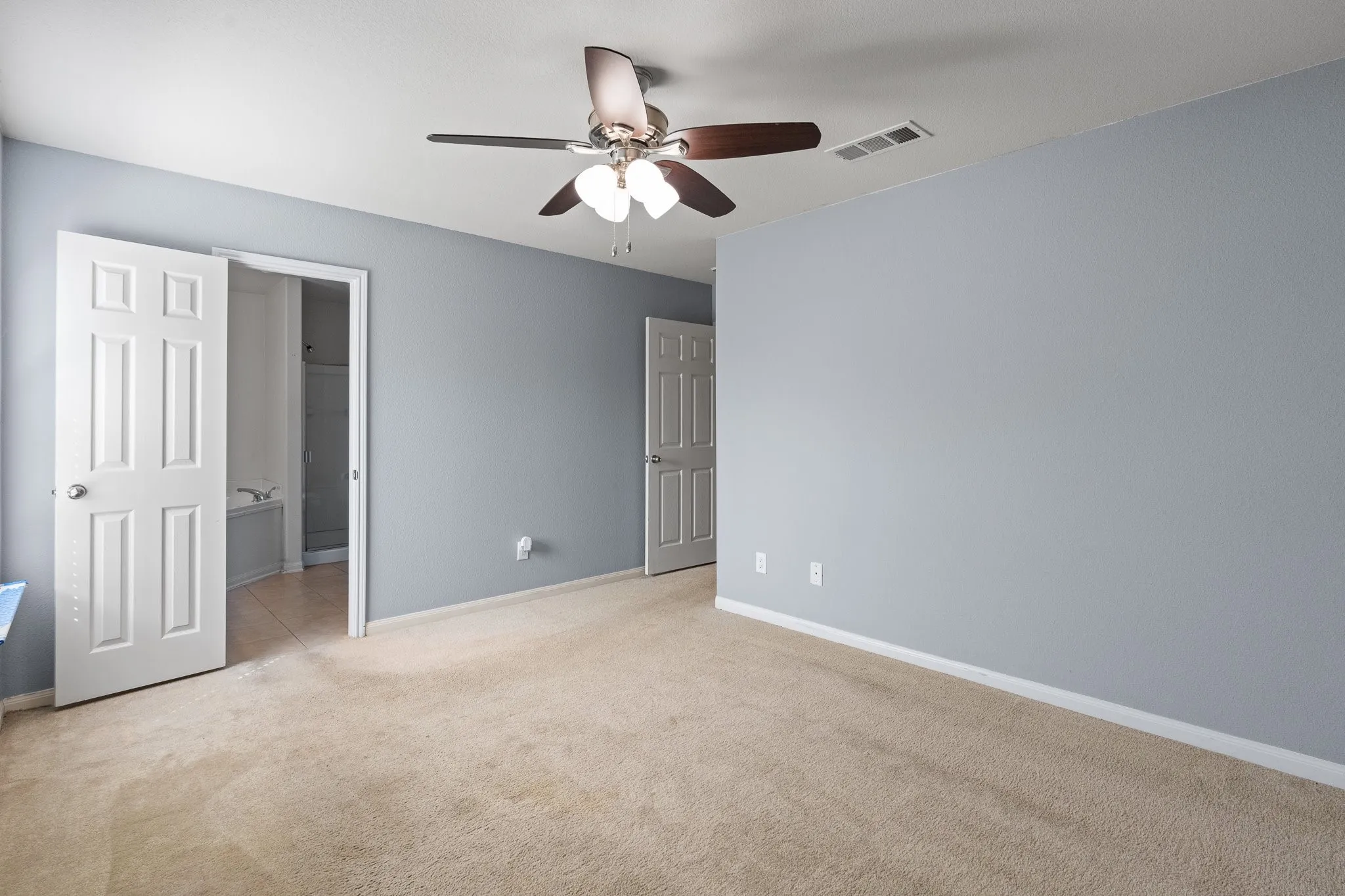 Primary Bedroom, door leading into the bathroom