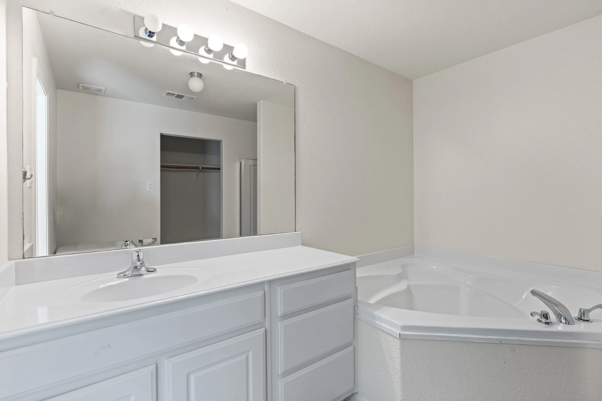 Primary Bathroom with soaking tub and separate shower, plenty of counter space
