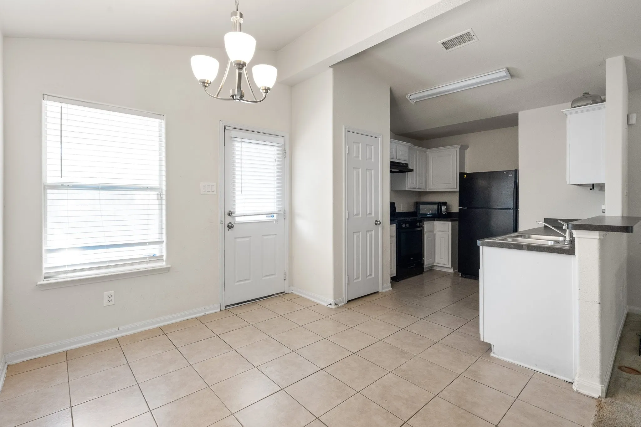 Eat in Kitchen area with door leading to the covered porch and backyard