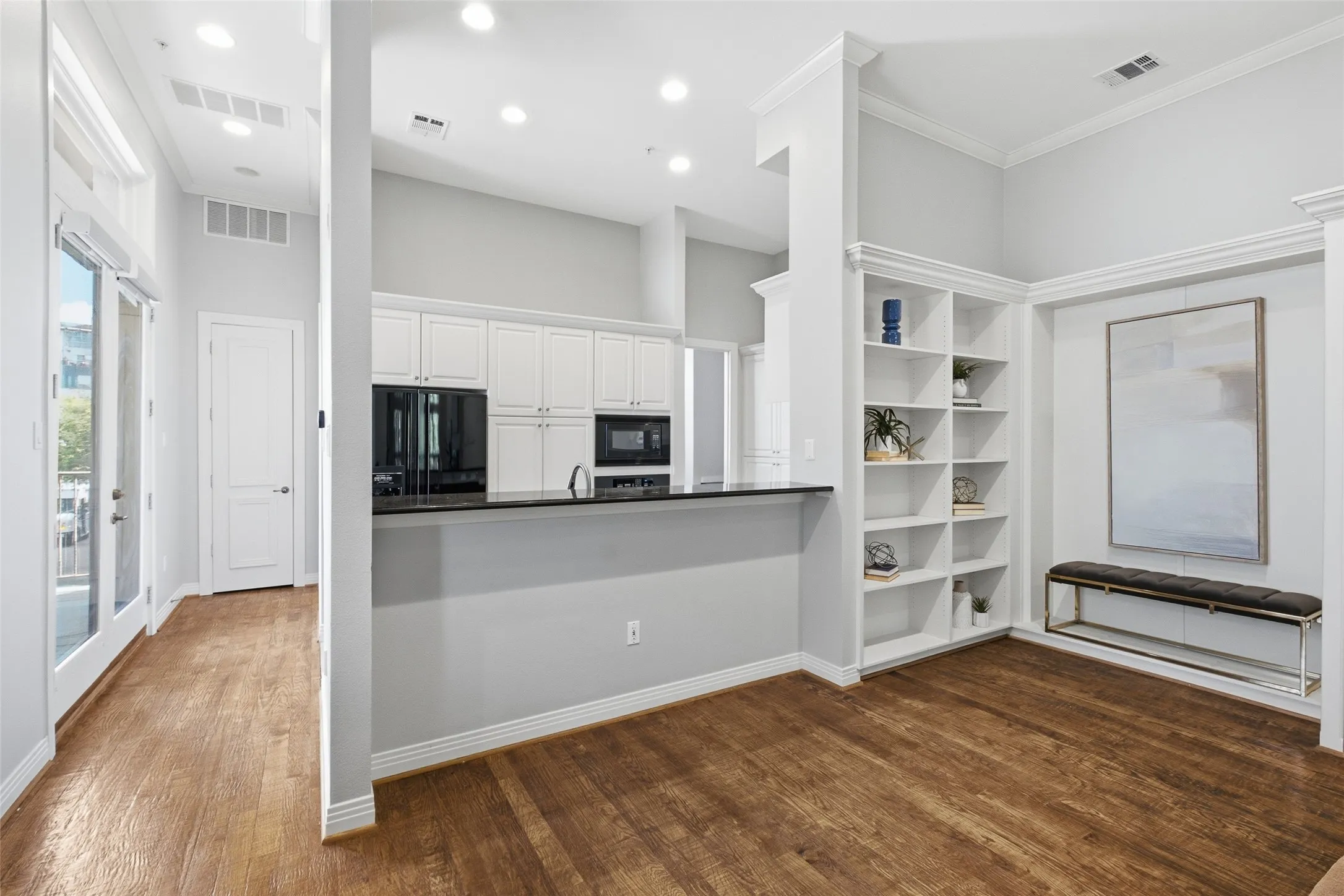 A granite breakfast bar opens the kitchen to the living space