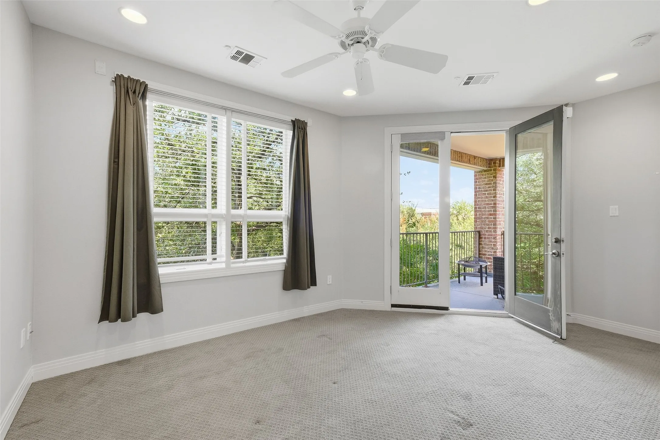Bedroom two measures 16x12 and looks out into the tree canopy on two sides