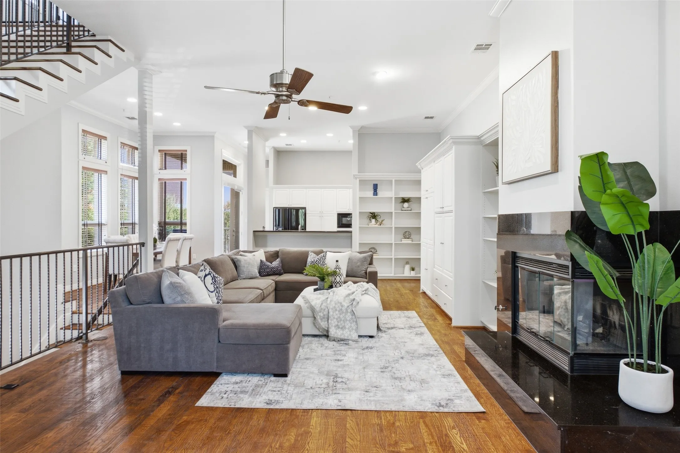A granite-surround fireplace and flanking built-ins make the whole level feel custom