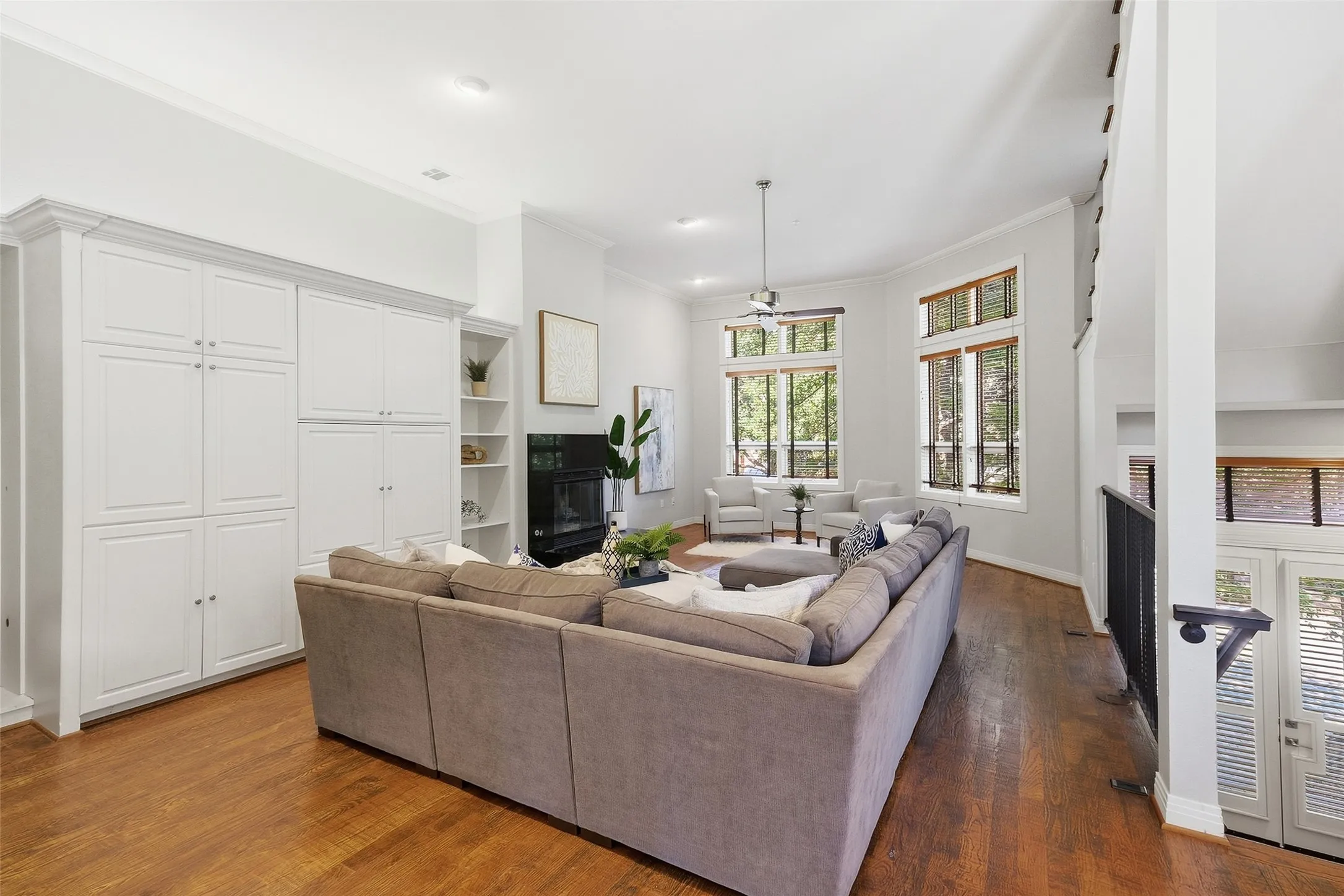 Floor-to-ceiling built-in cabinetry and a fireplace anchor the main living level