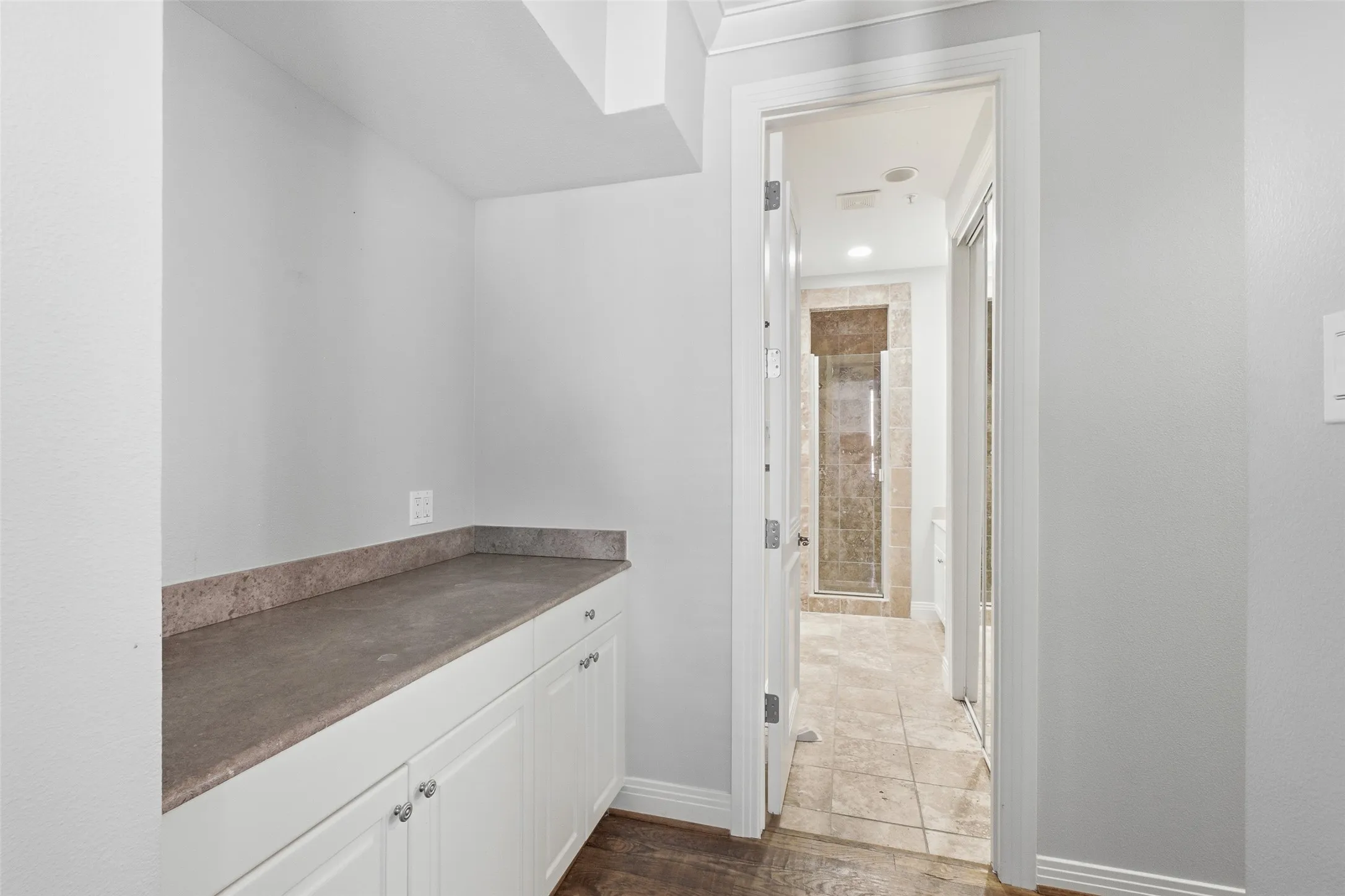 A run of built-in cabinetry and counter in the lower hall - storage you will actually use
