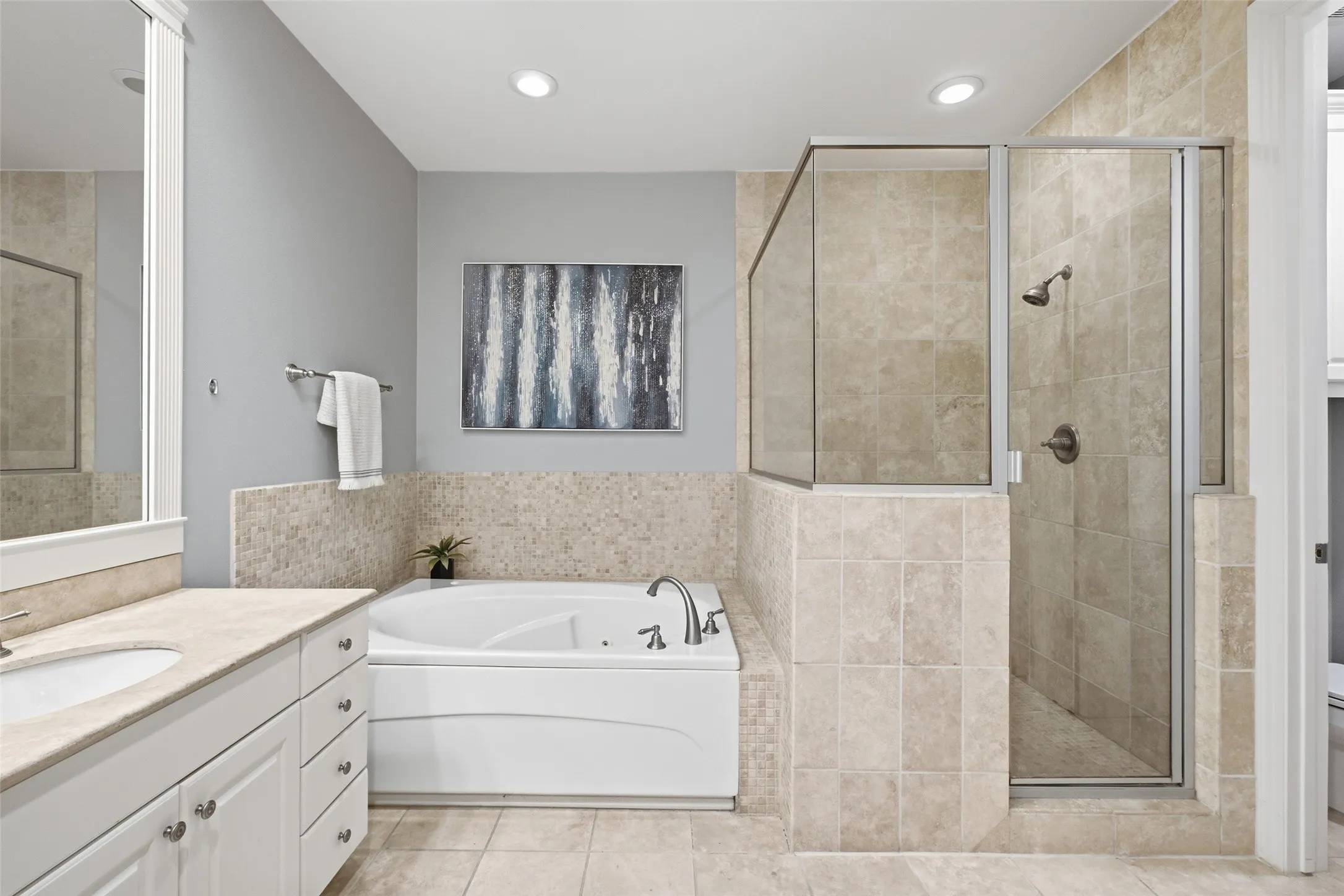 Soak in the garden tub or step into the separate glass-and-tile shower - both are right here