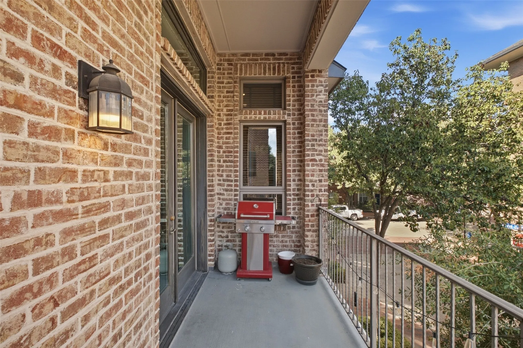 Covered and sheltered, this balcony is built for grilling and long Texas evenings outside
