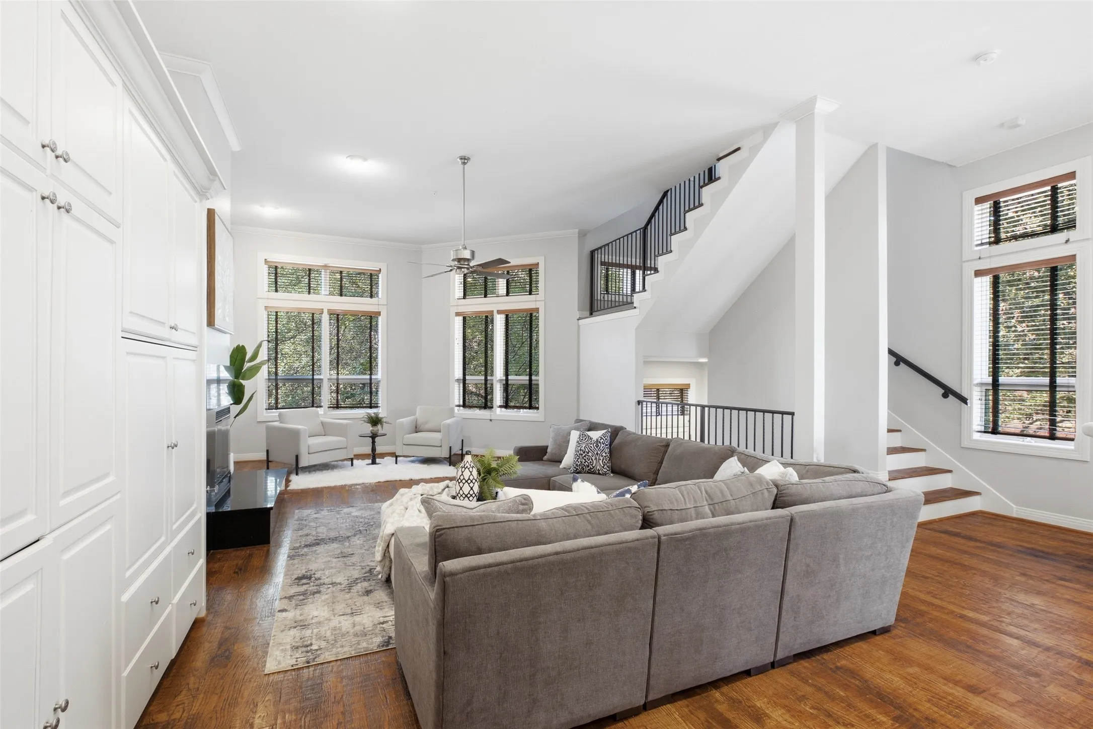 The living space runs a full 32 feet, with tall windows and hardwoods end to end